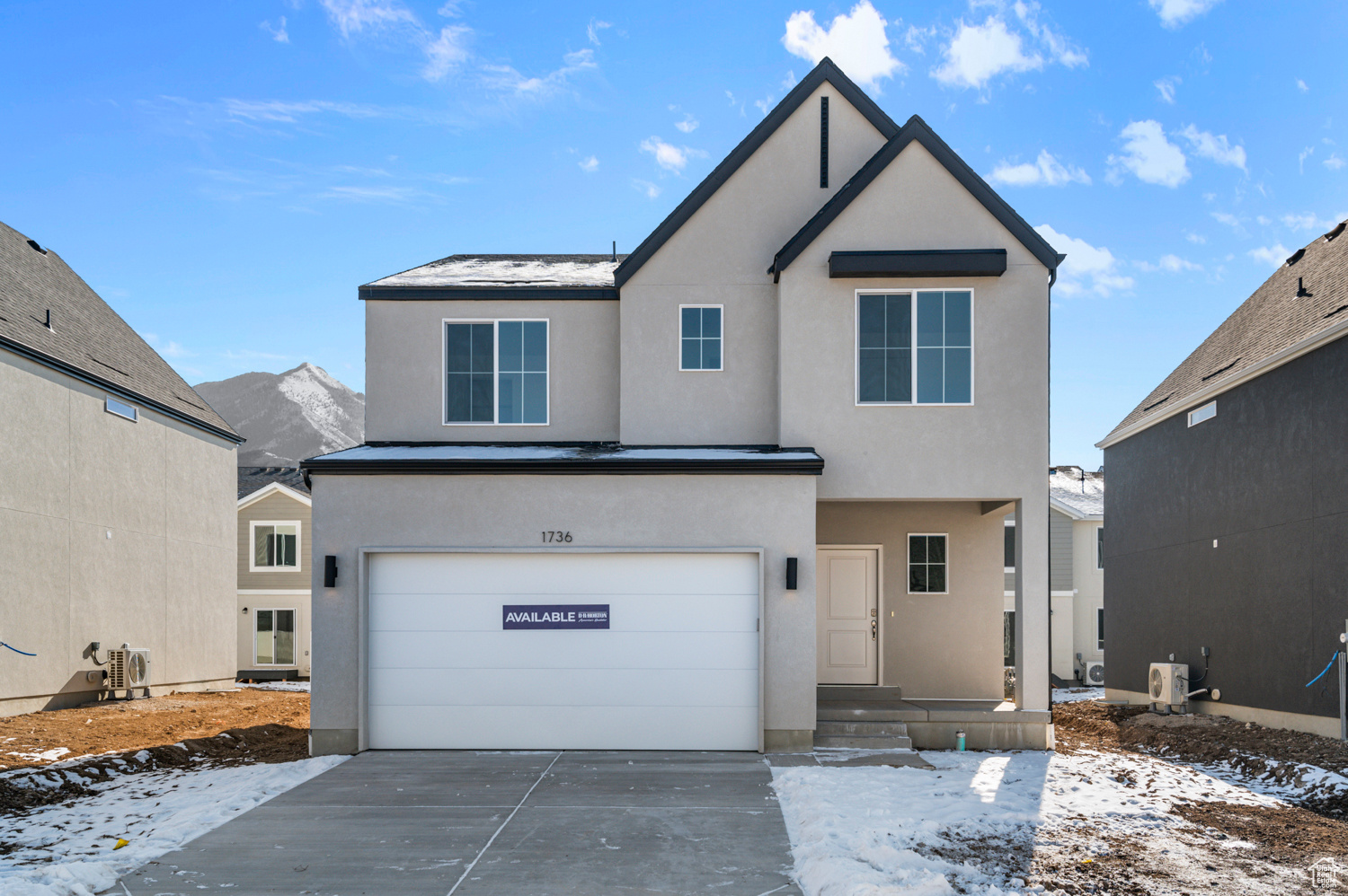 View of front of house featuring a mountain view and a garage