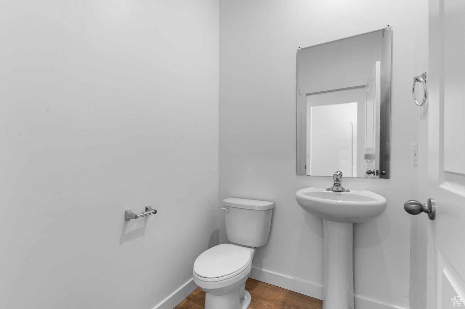 Bathroom featuring hardwood / wood-style flooring and toilet