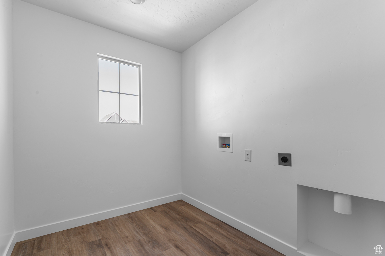 Clothes washing area featuring electric dryer hookup, hookup for a washing machine, and dark wood-type flooring