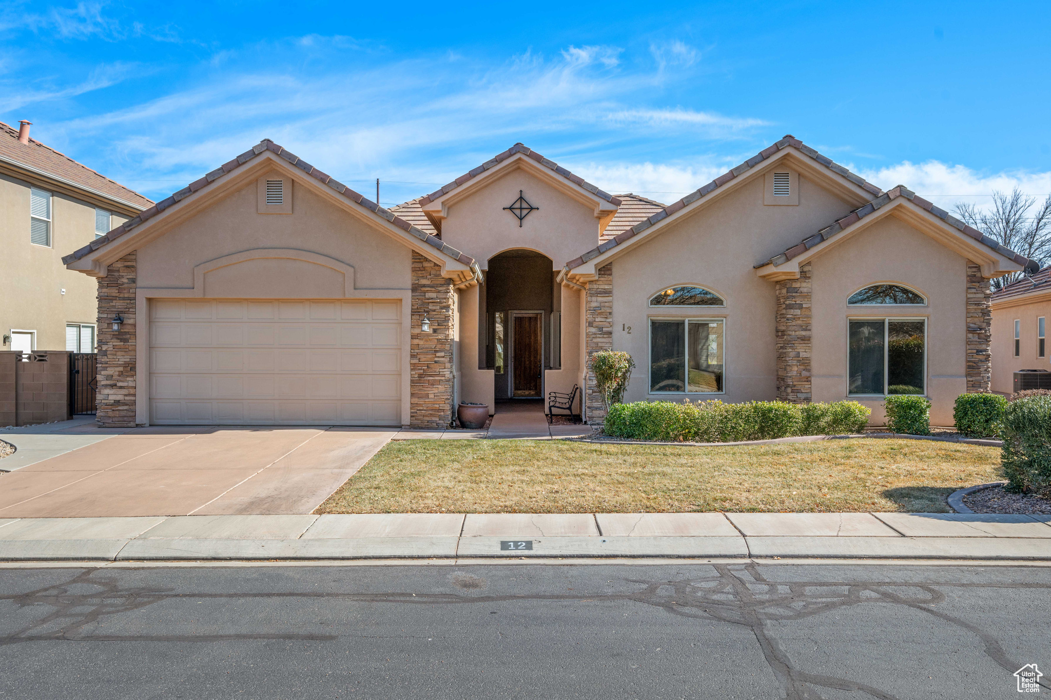 View of front of house featuring a garage and a front yard