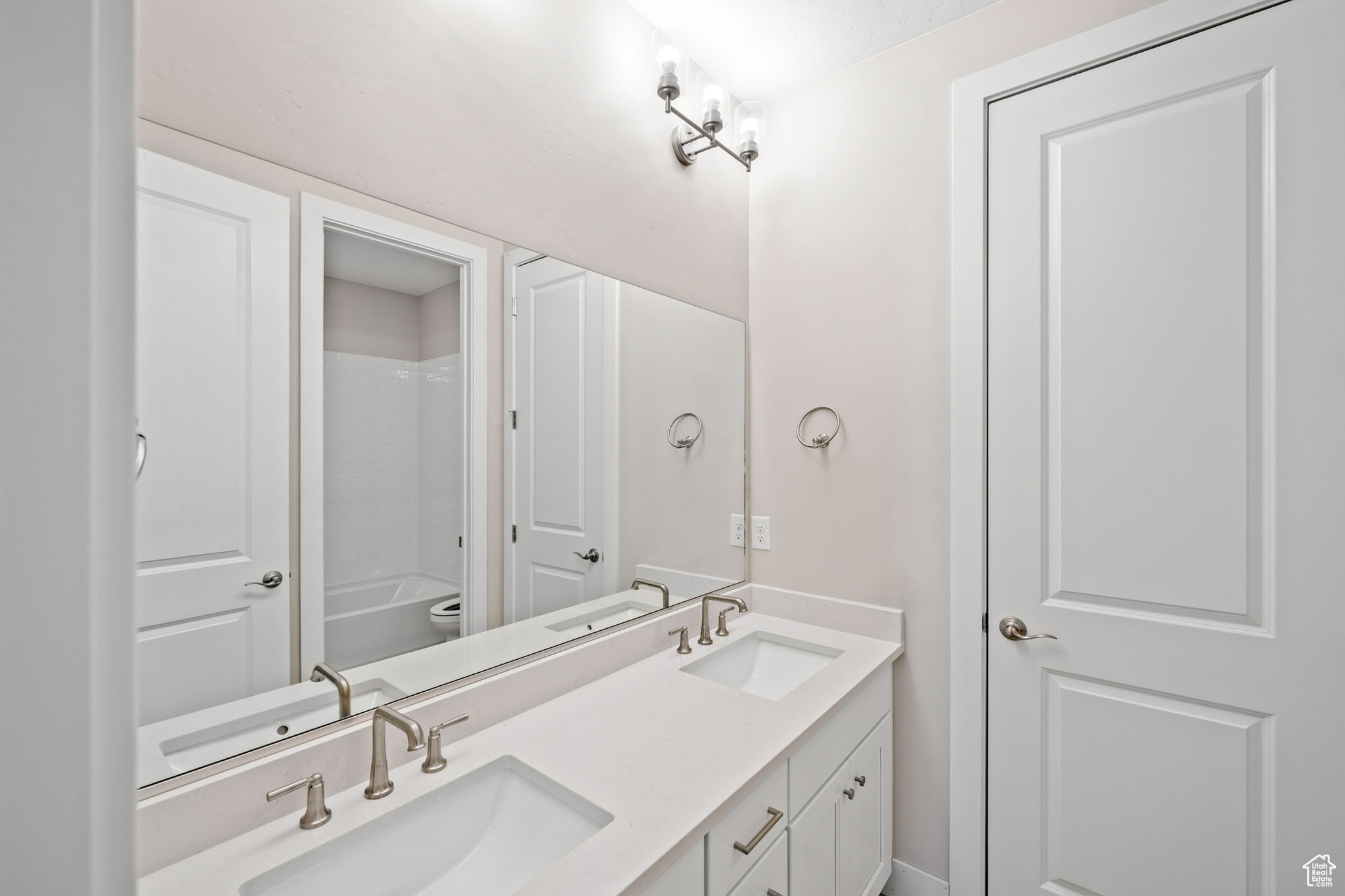 Full bathroom with vanity, shower / bathtub combination, and toilet