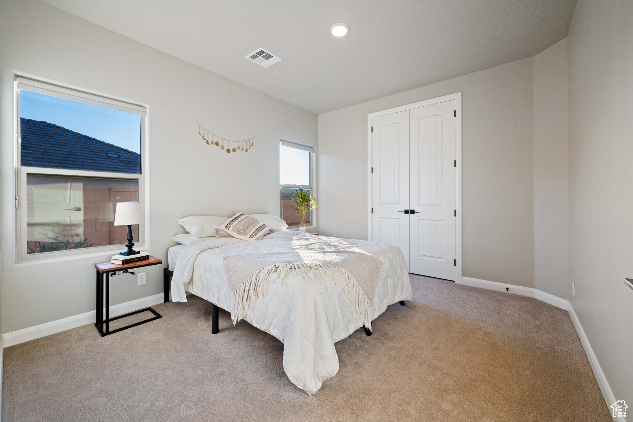 Carpeted bedroom featuring a closet