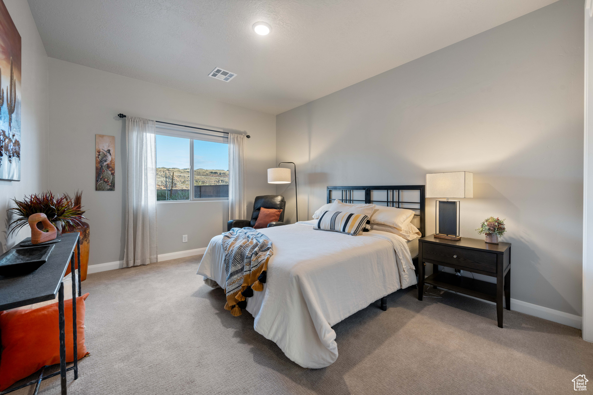 Bedroom with light colored carpet