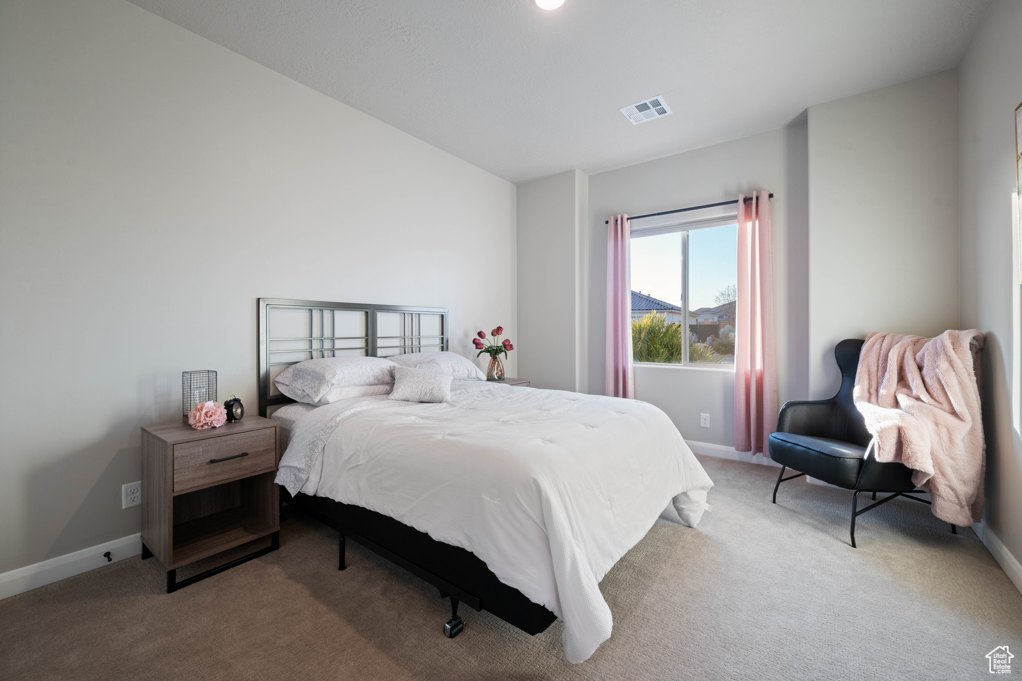 Bedroom with light carpet