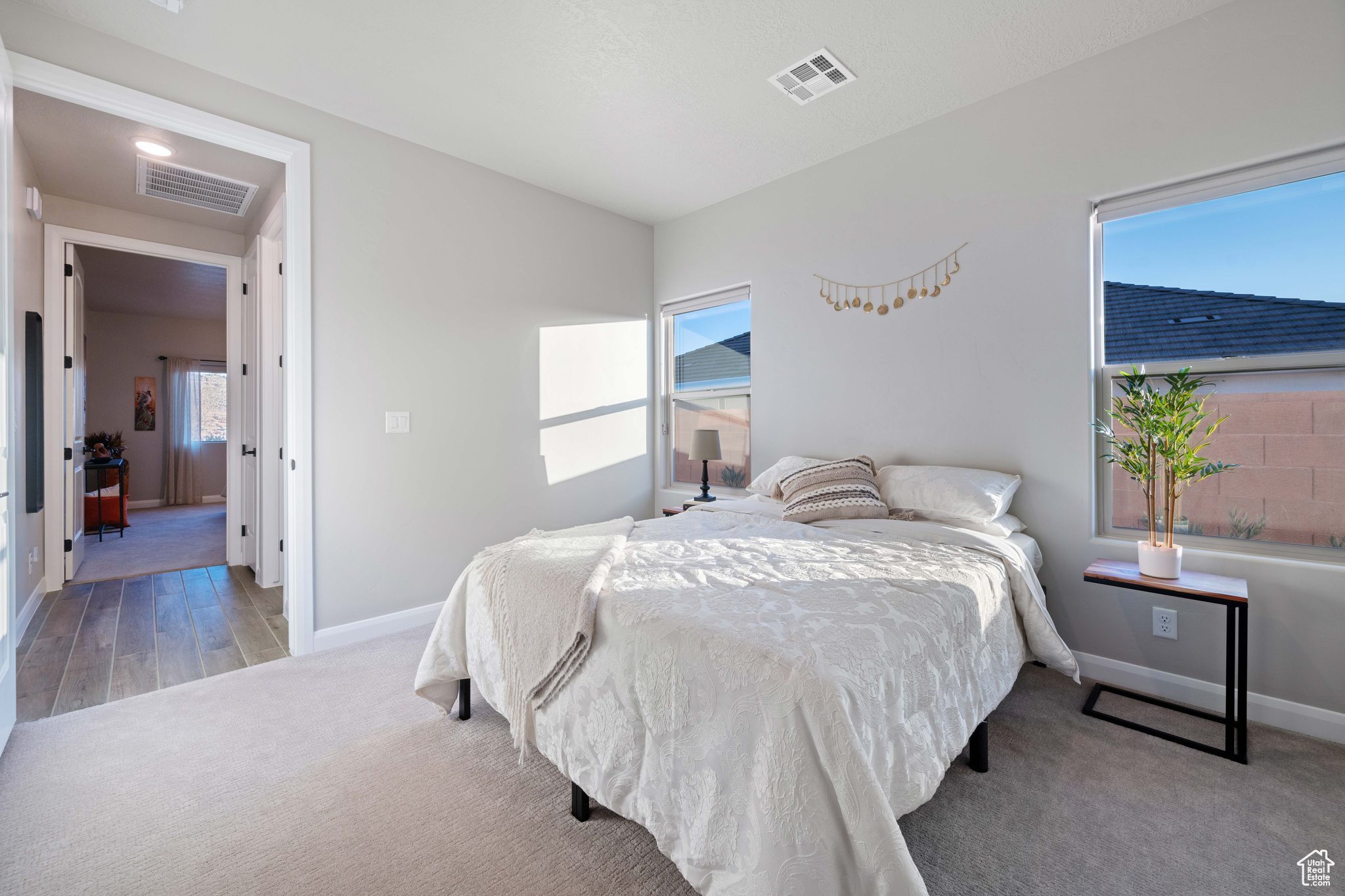 Bedroom featuring light colored carpet