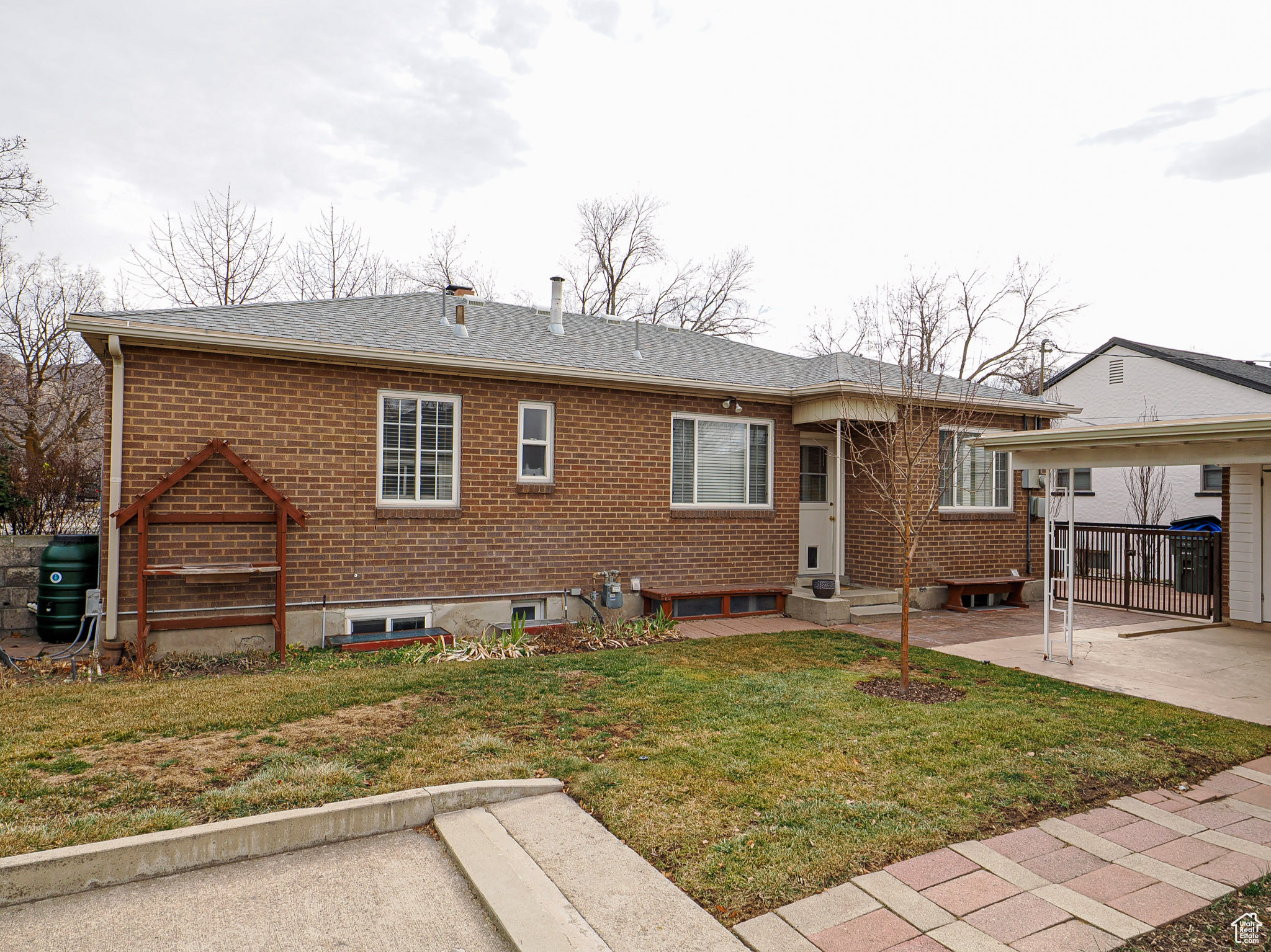 Rear view of property with a yard and a patio area