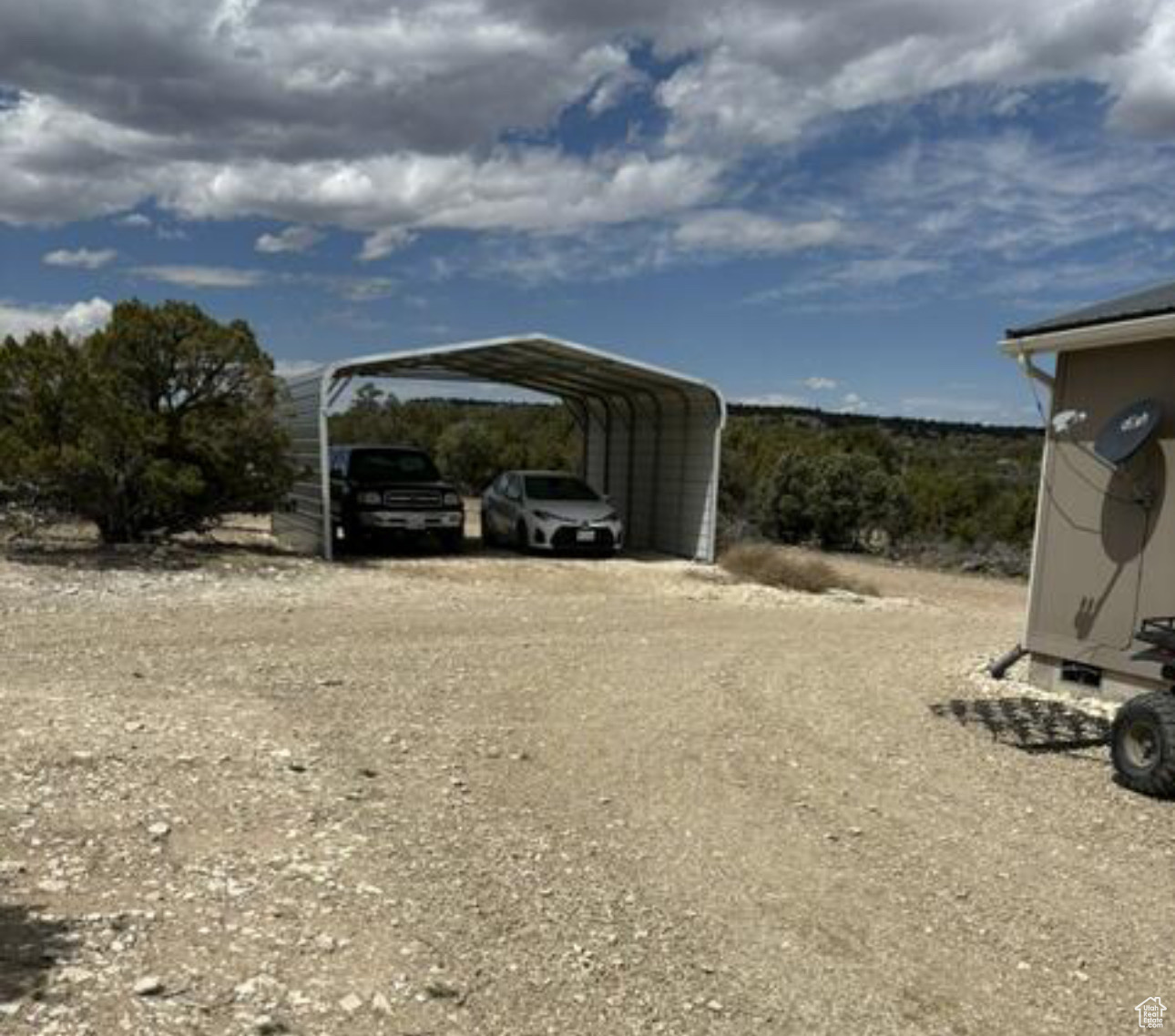 View of vehicle parking featuring a carport