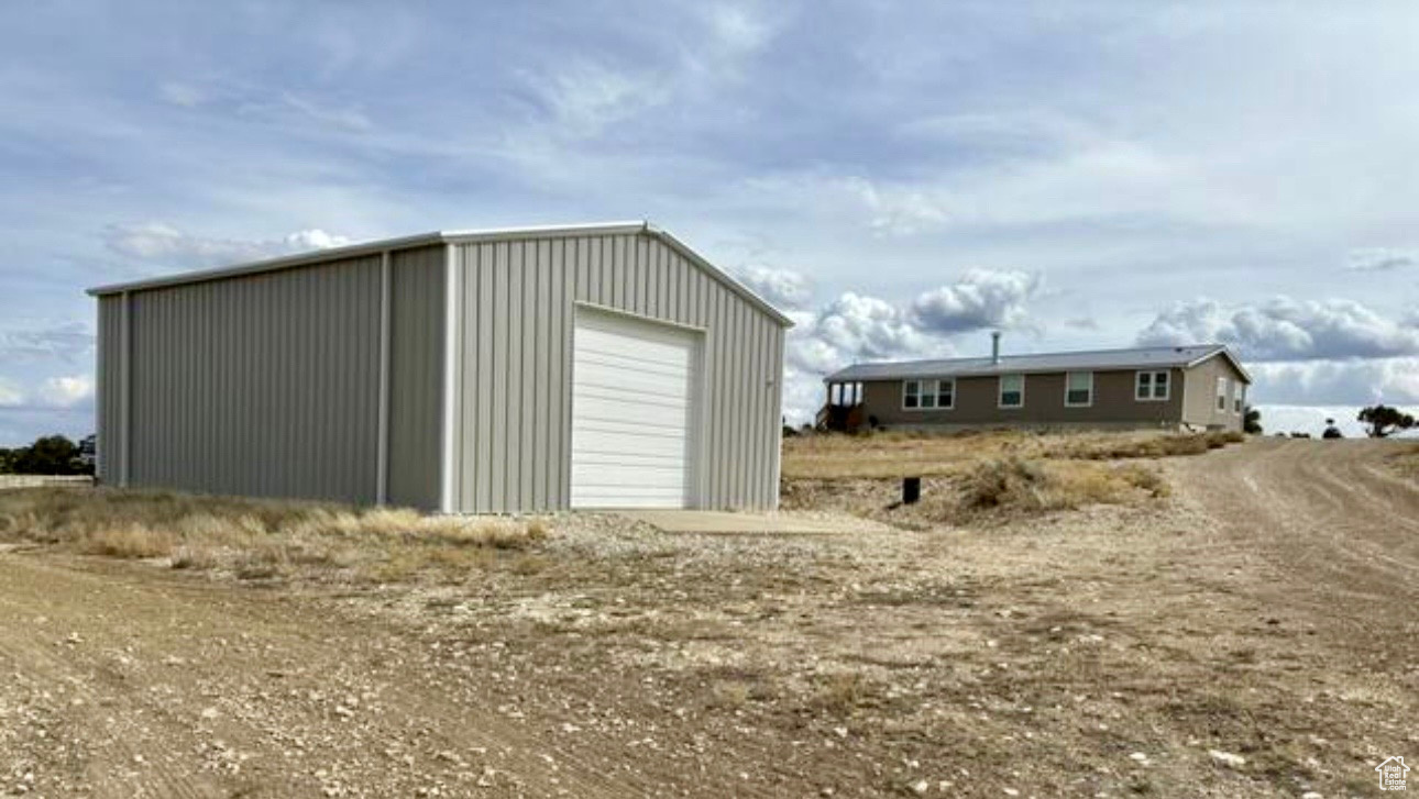 View of outbuilding featuring a garage