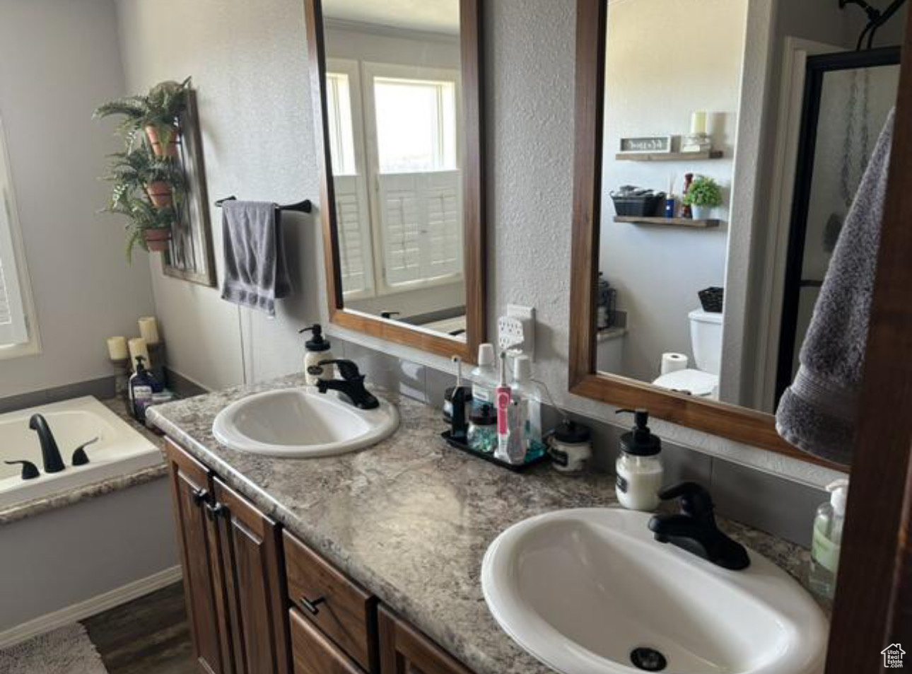 Bathroom featuring vanity, a bathtub, and toilet