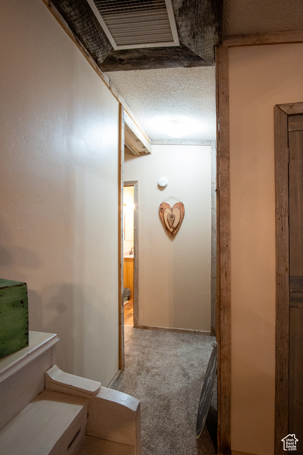 Hall with a textured ceiling and carpet flooring