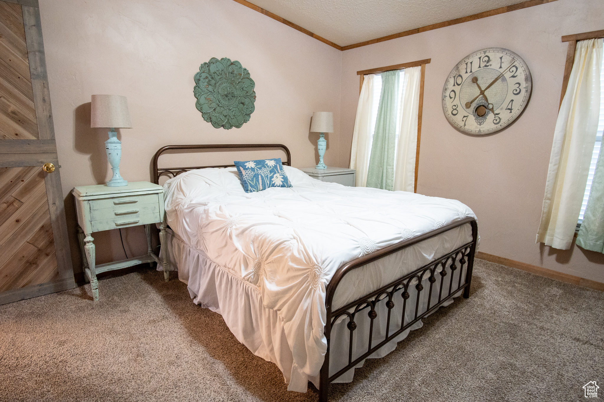 Carpeted bedroom with crown molding and a textured ceiling