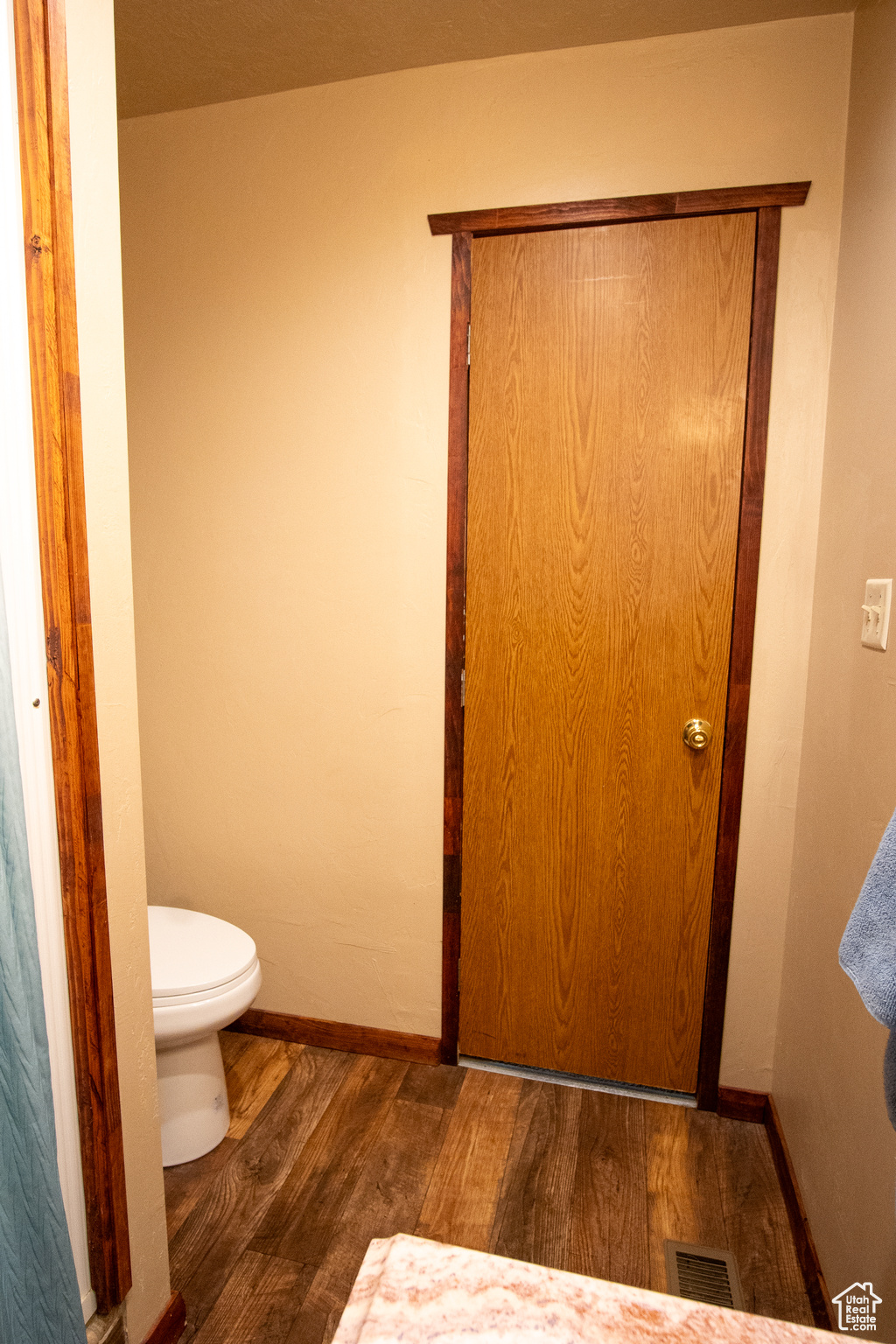 Bathroom with wood-type flooring and toilet