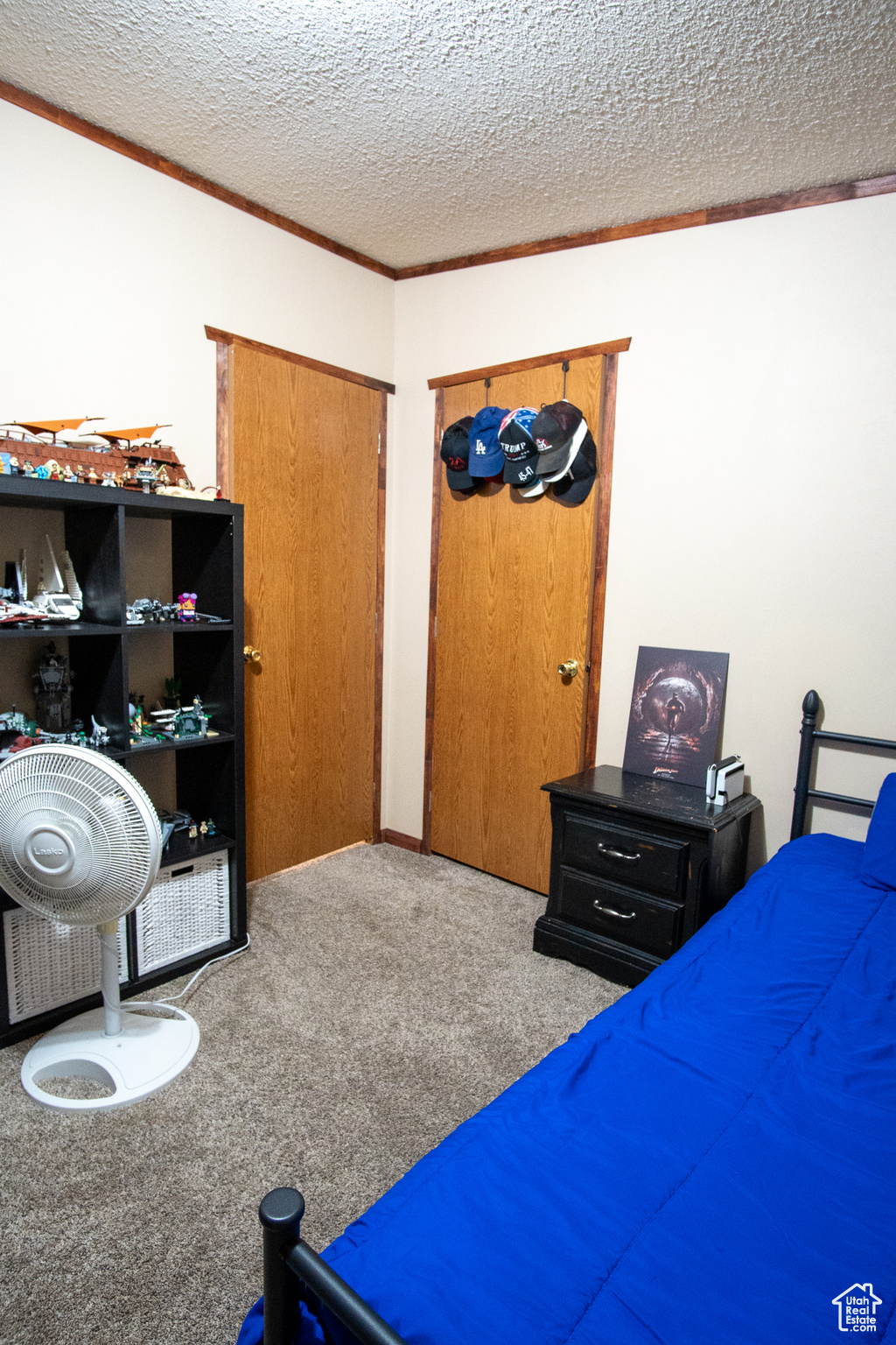 Carpeted bedroom featuring a textured ceiling