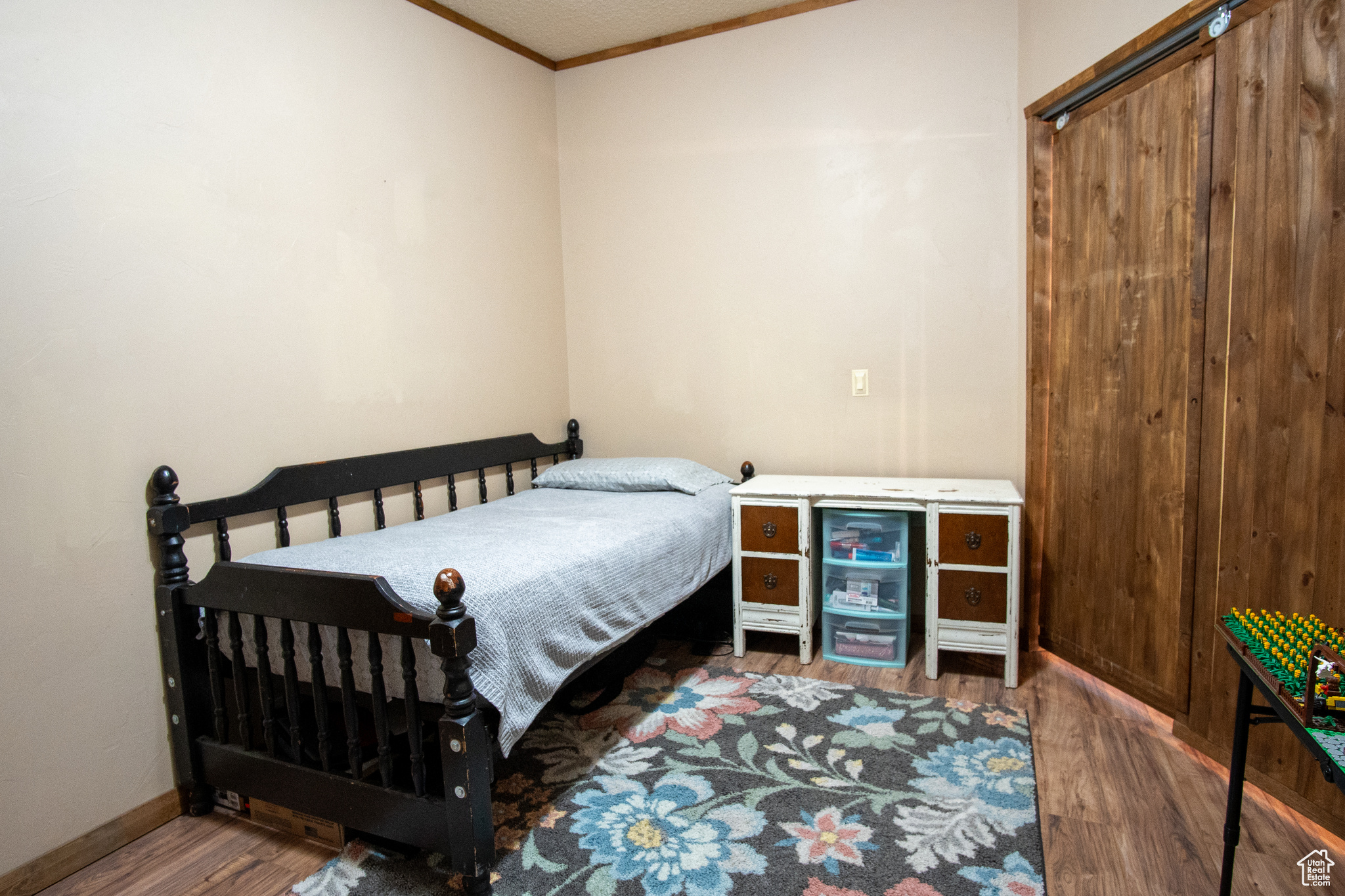 Bedroom featuring wood-type flooring and ornamental molding