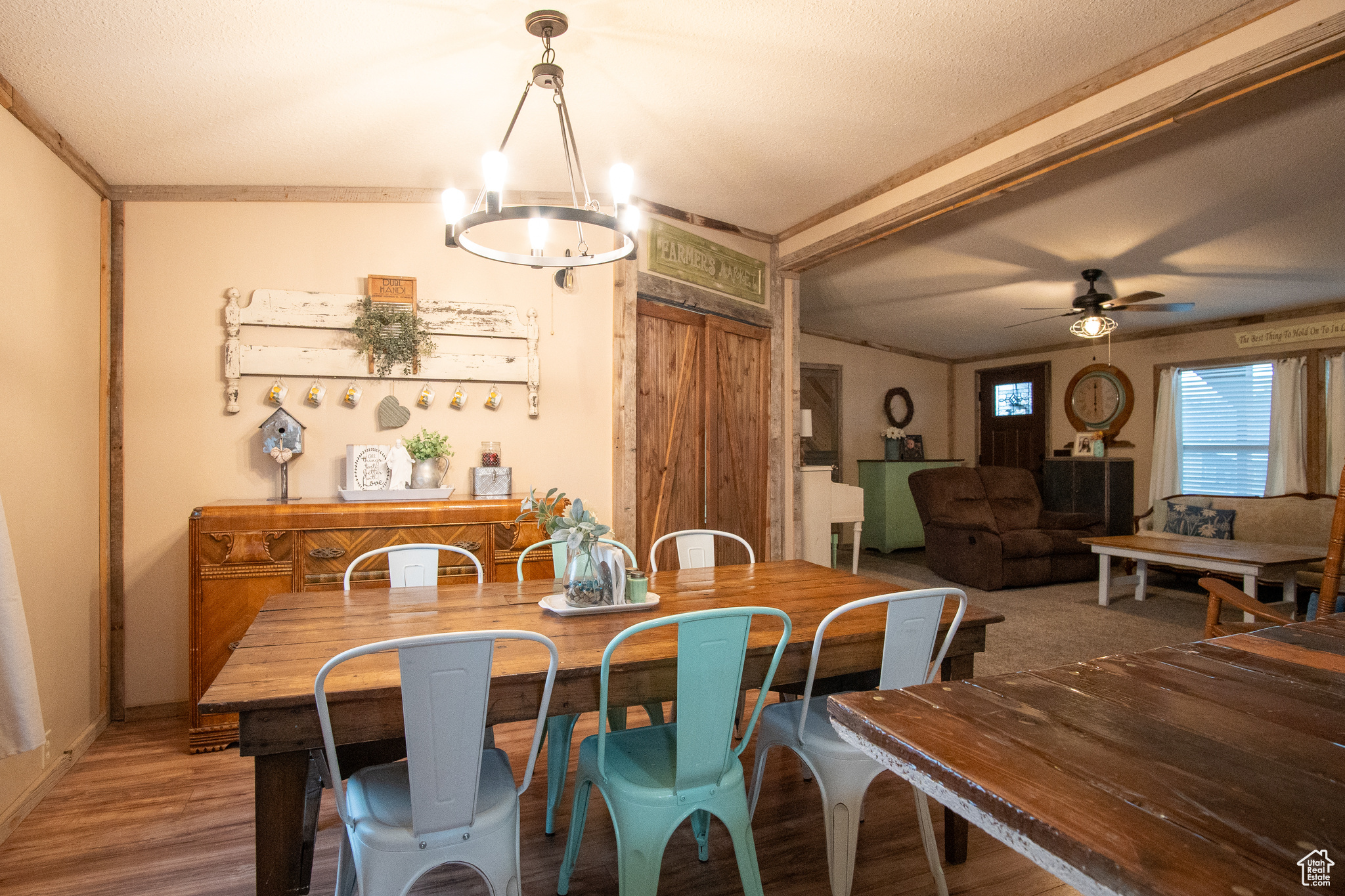 Dining room featuring hardwood / wood-style floors and ceiling fan with notable chandelier