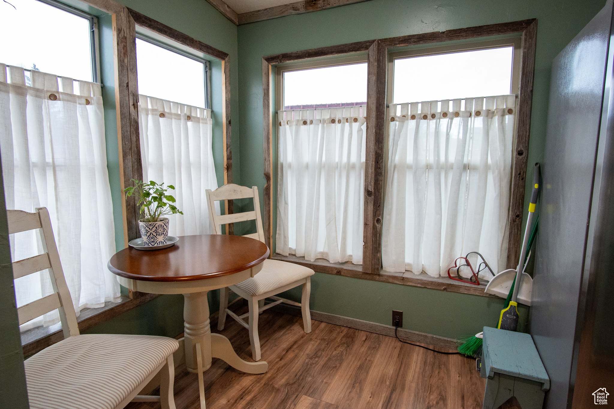 Dining space with a wealth of natural light and wood-type flooring