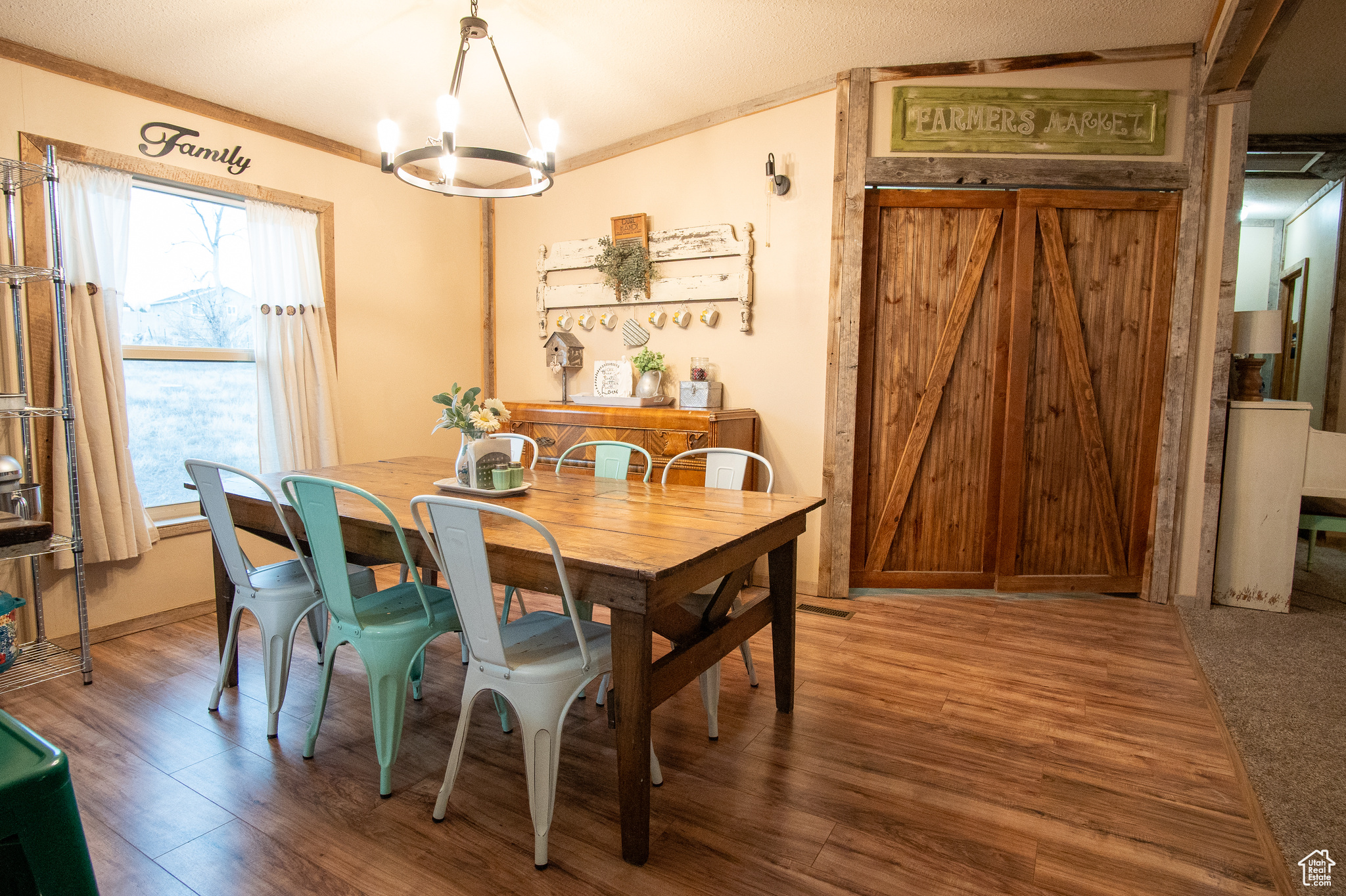 Dining space with an inviting chandelier, crown molding, and wood-type flooring