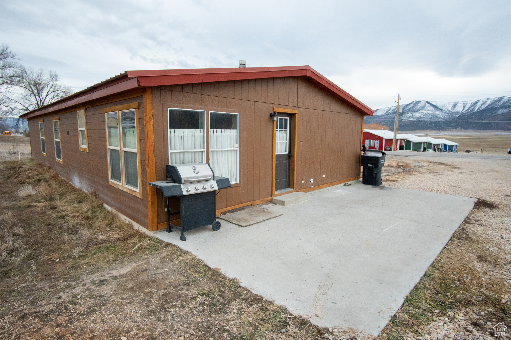 Back of property featuring a mountain view and a patio