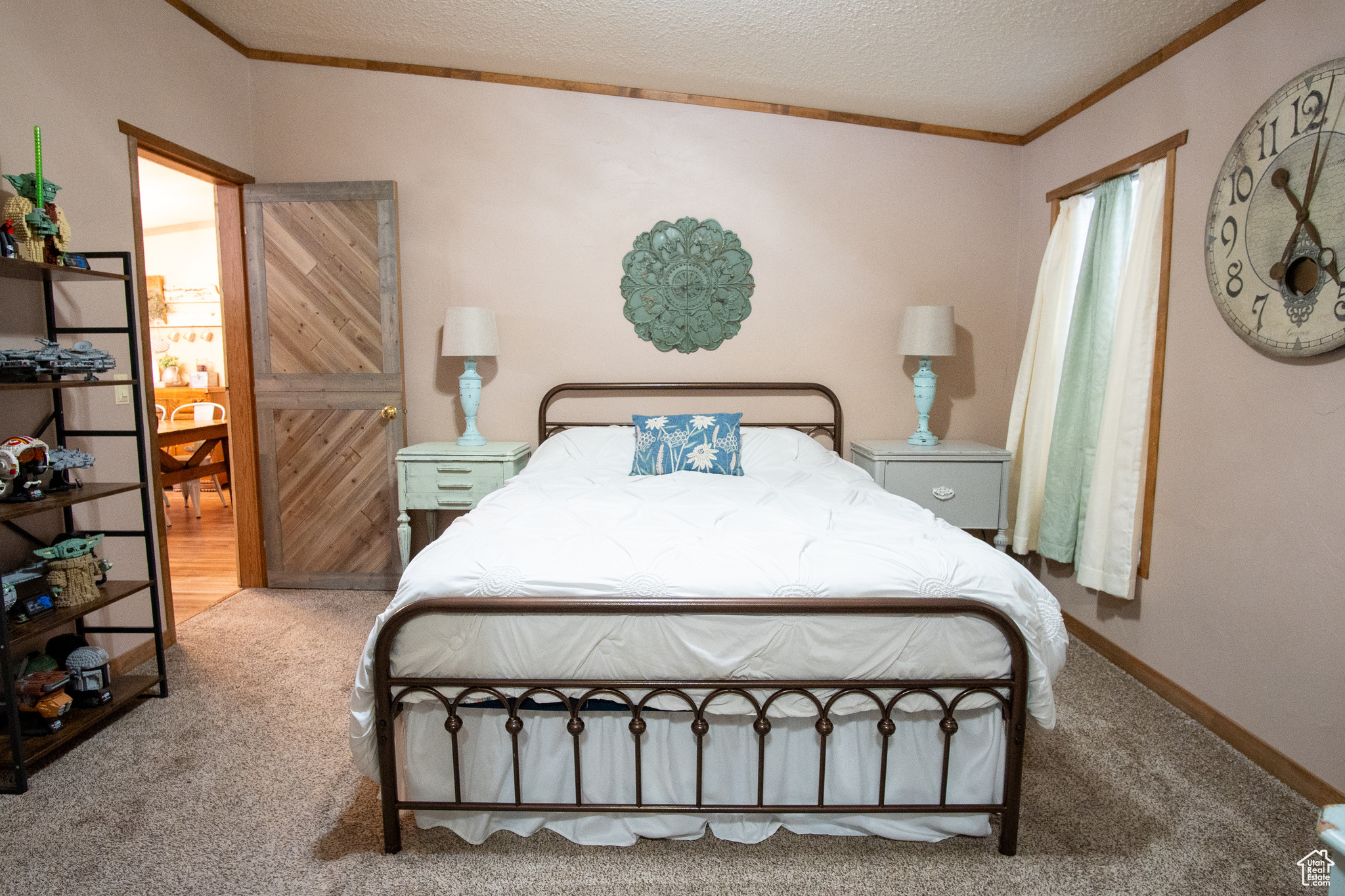 Carpeted bedroom with ornamental molding and a textured ceiling