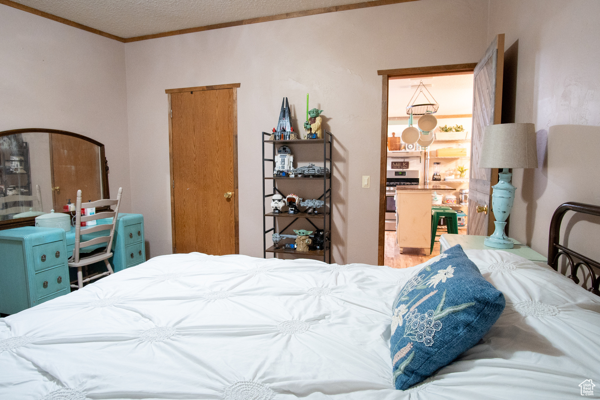 Bedroom with crown molding and a textured ceiling