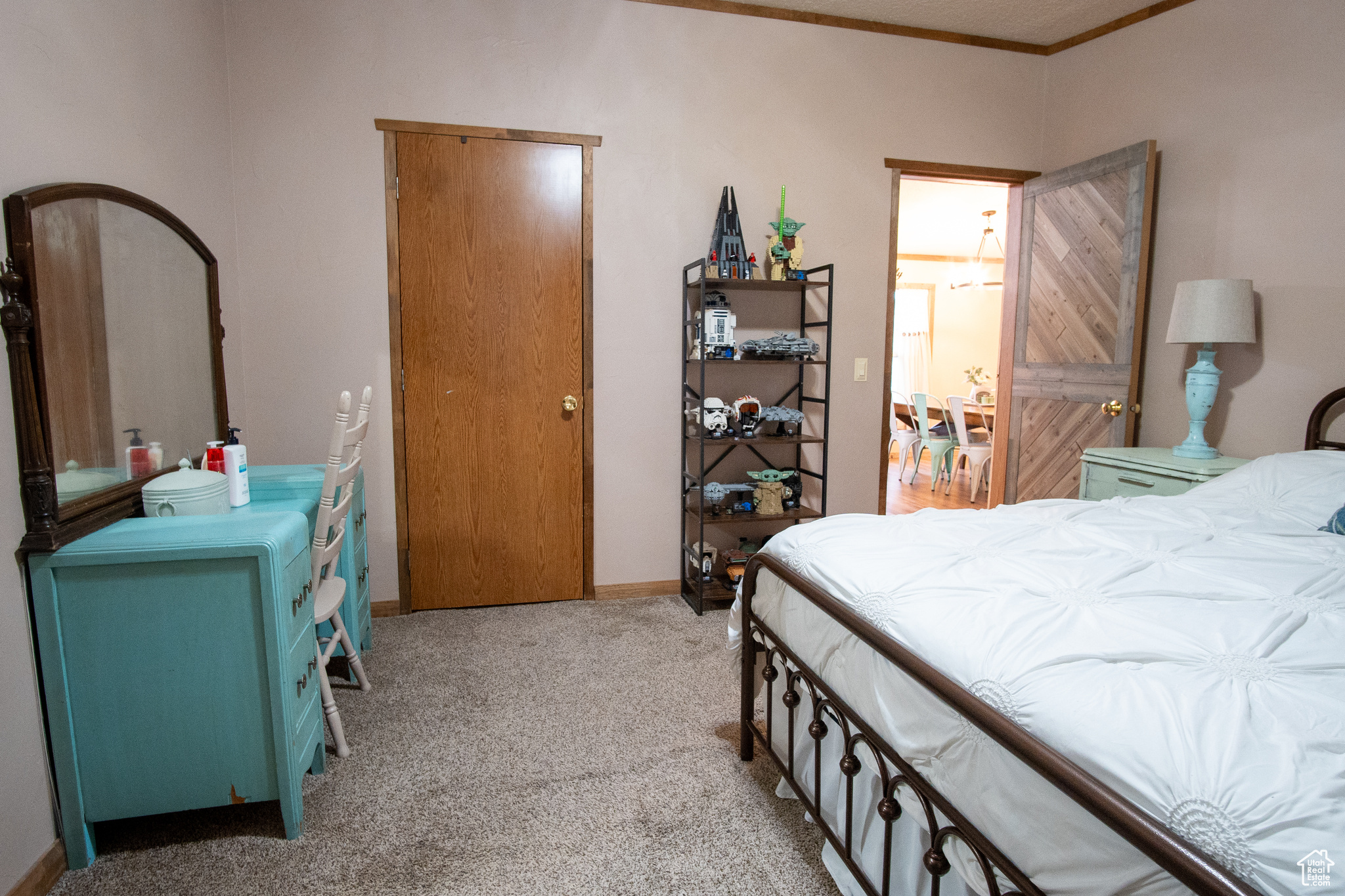 Carpeted bedroom featuring crown molding