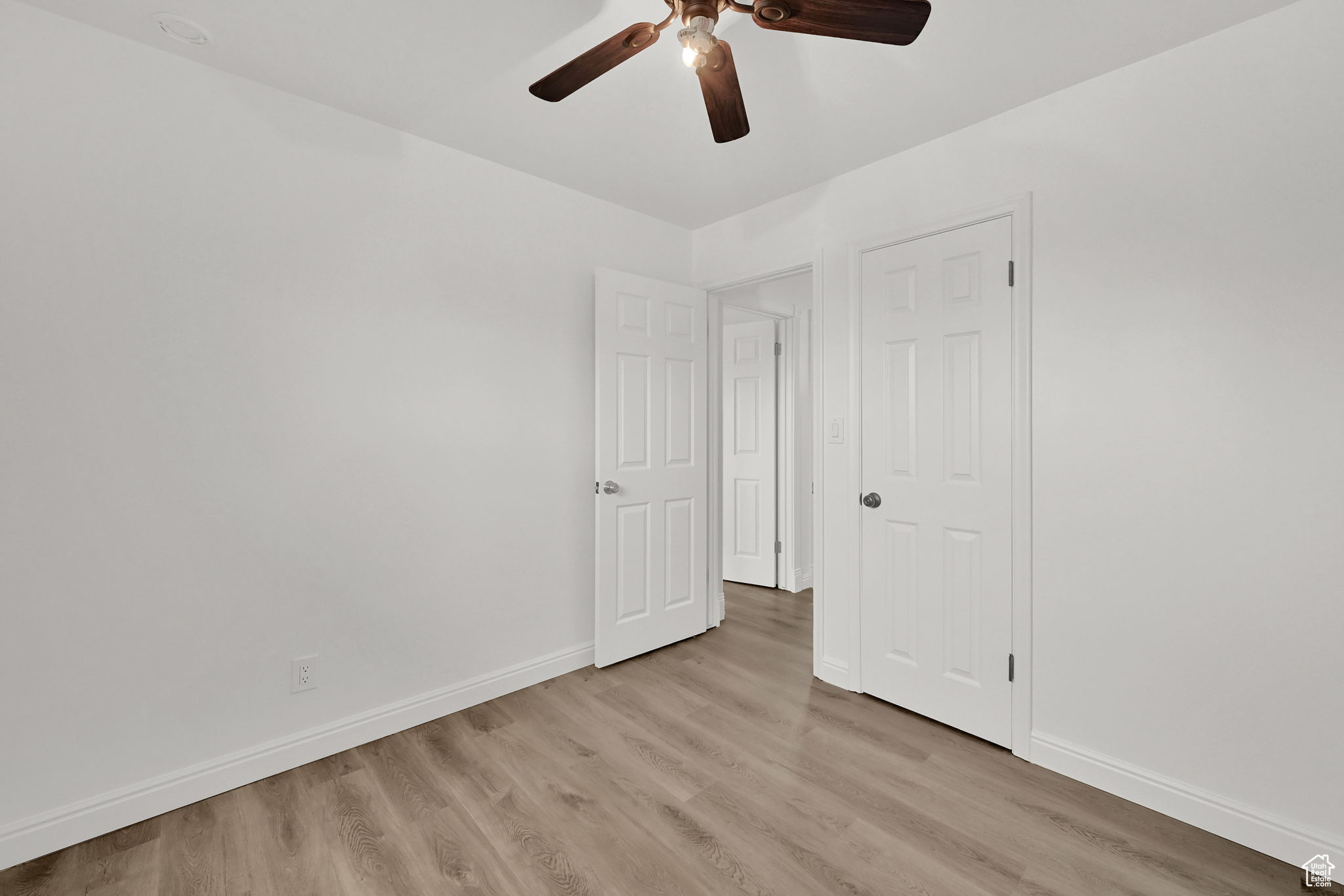 Unfurnished bedroom with light hardwood / wood-style floors and ceiling fan