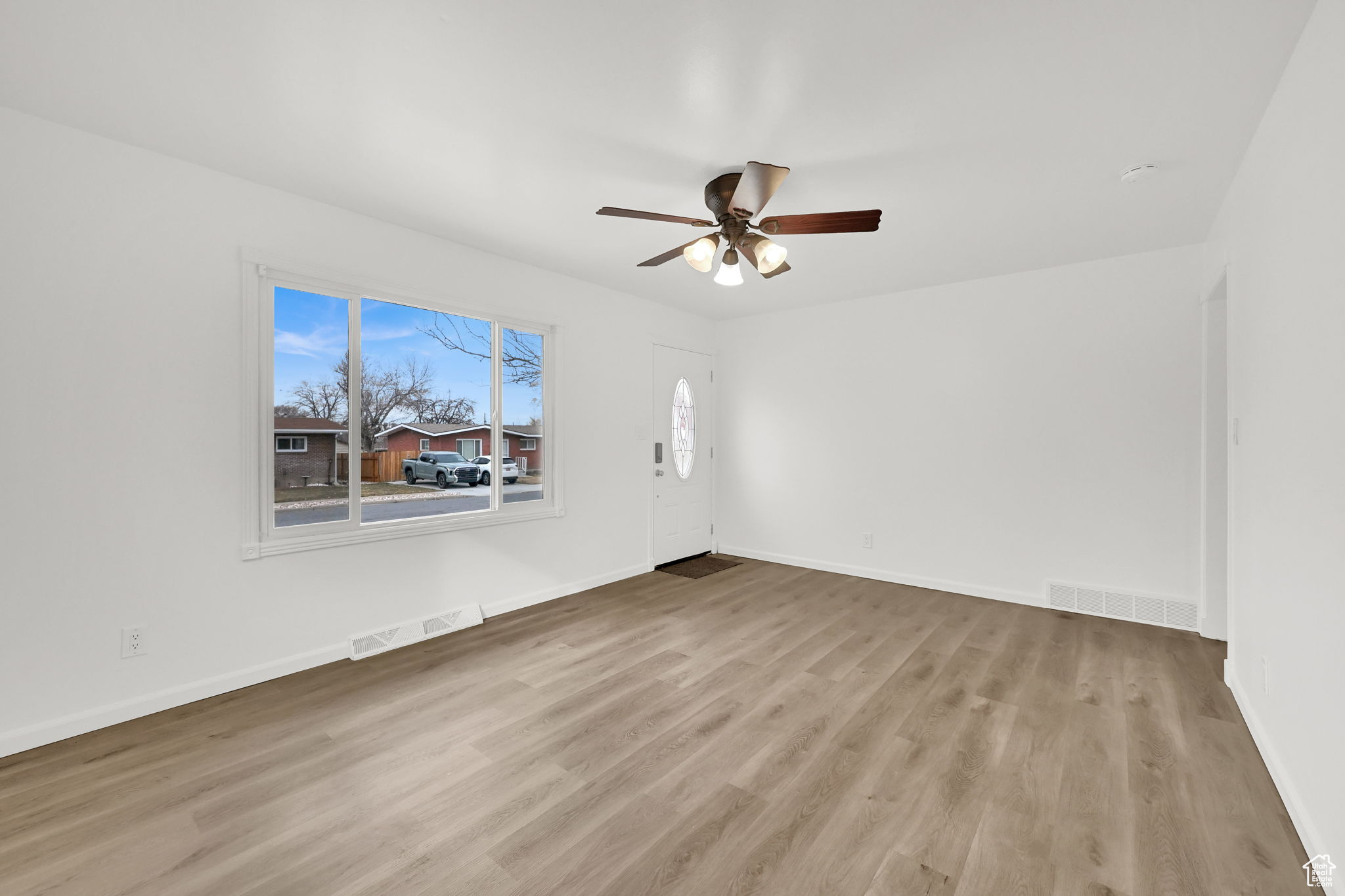 Spare room with ceiling fan and light wood-type flooring