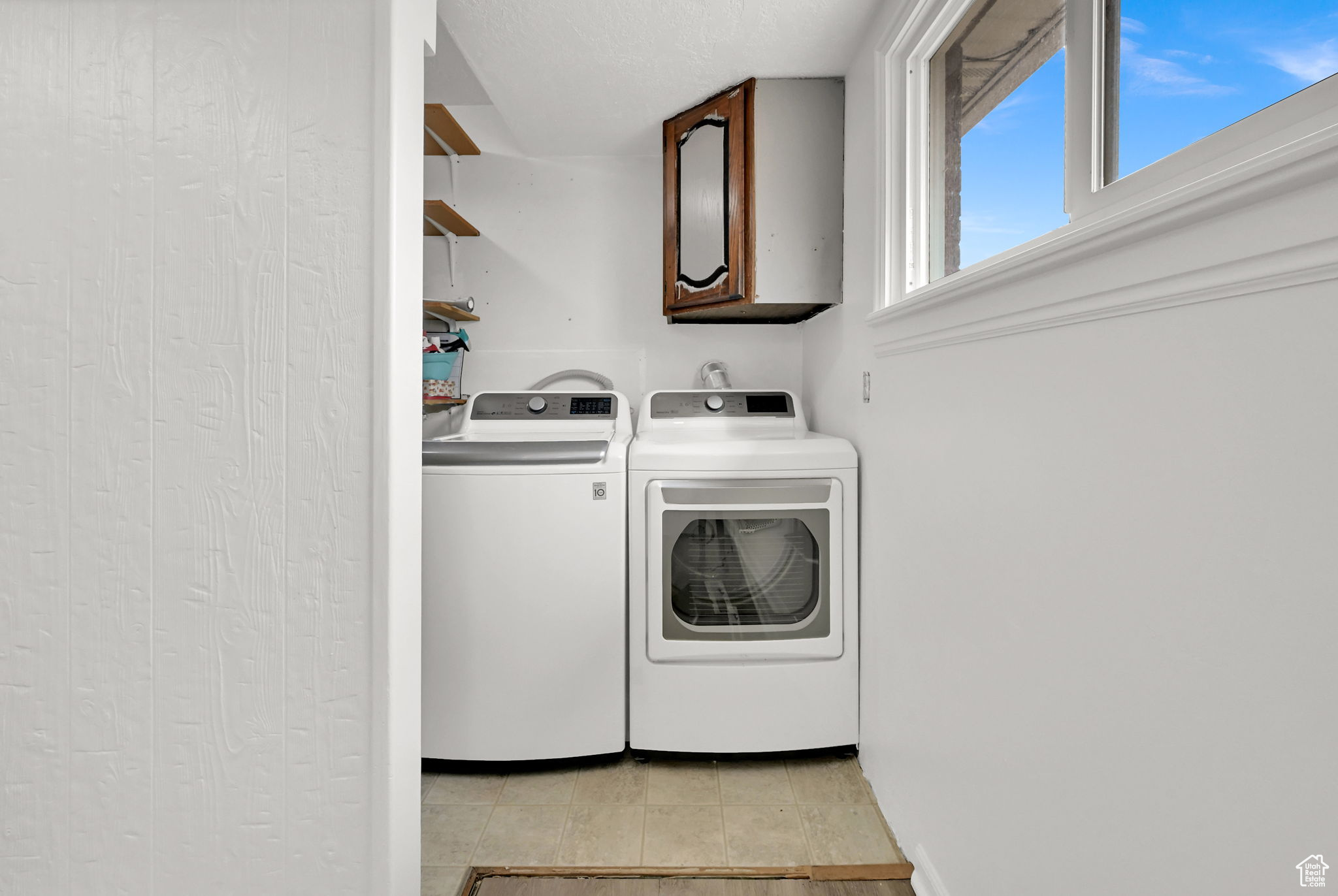 Laundry room featuring cabinets and washer and dryer