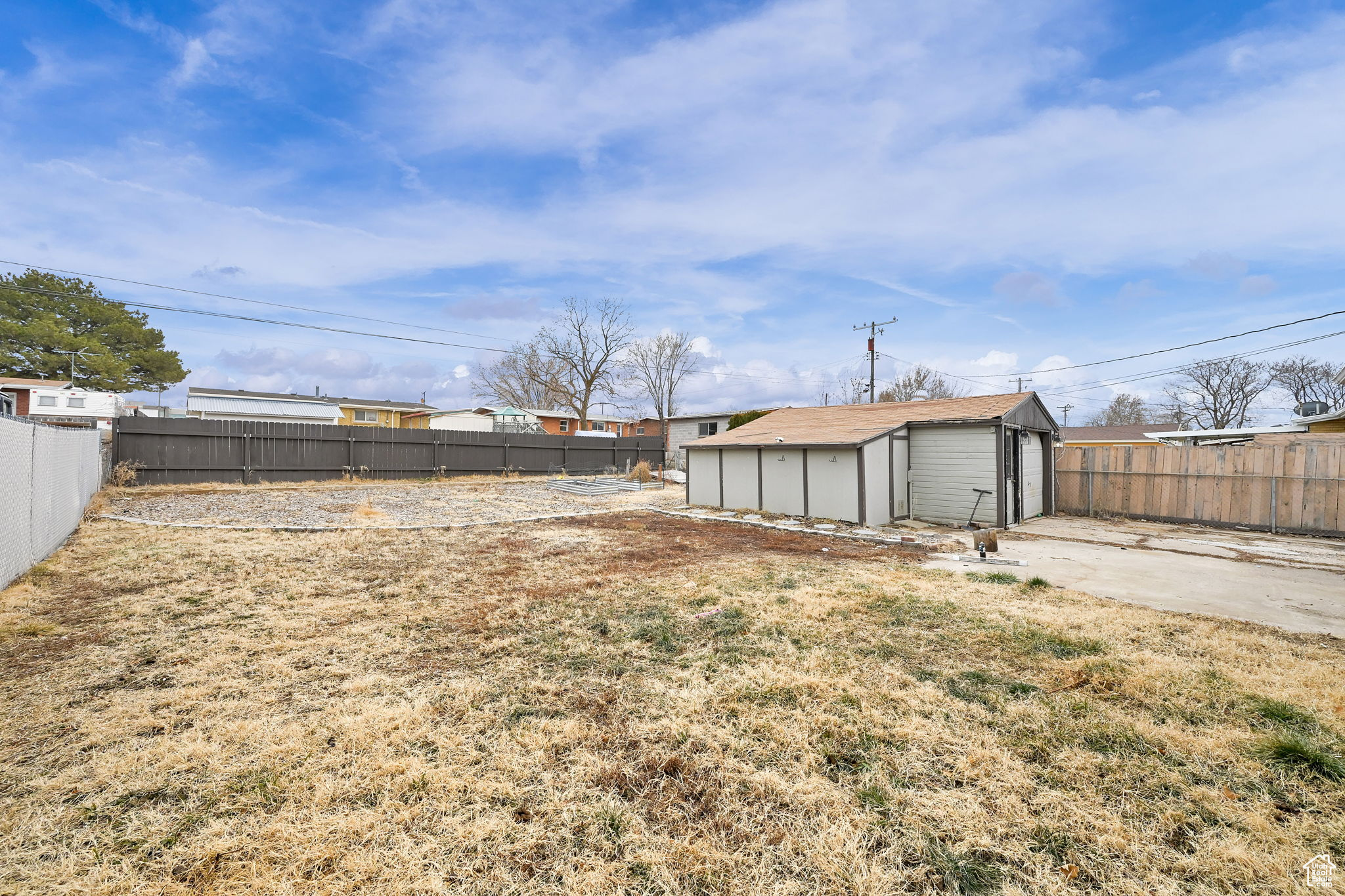 View of yard featuring a garage and an outdoor structure