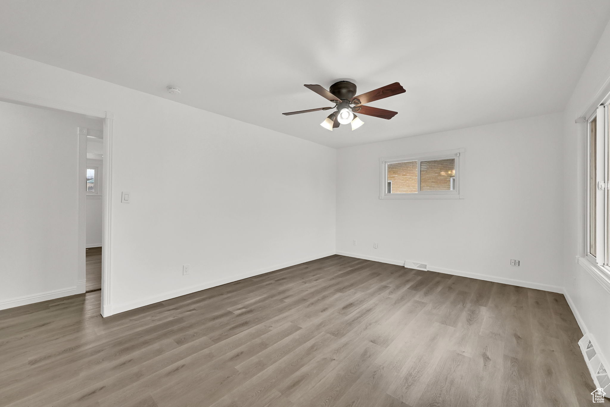 Spare room with ceiling fan and light wood-type flooring