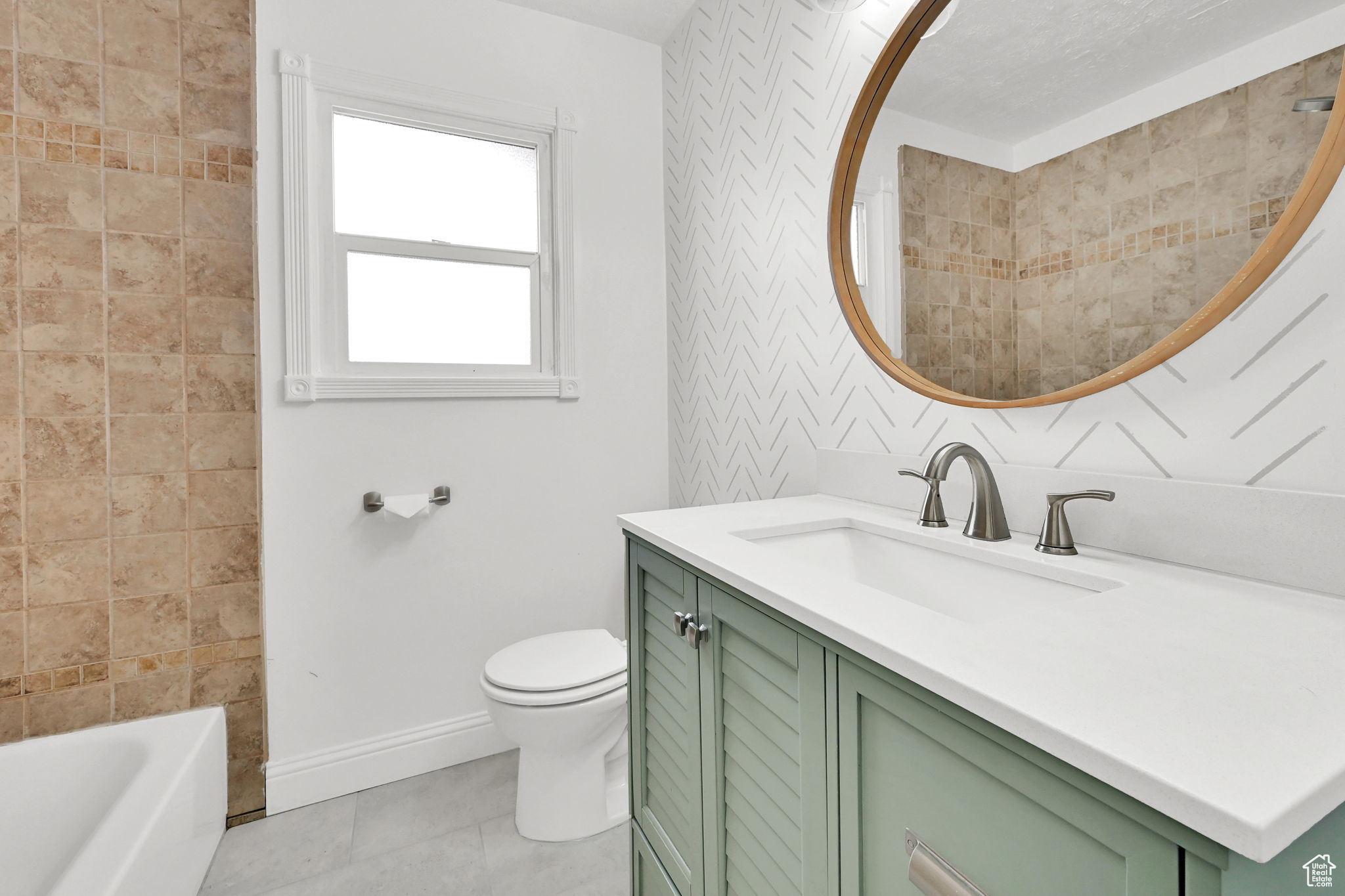 Full bathroom with vanity, tile patterned floors, toilet, and shower / bath combination