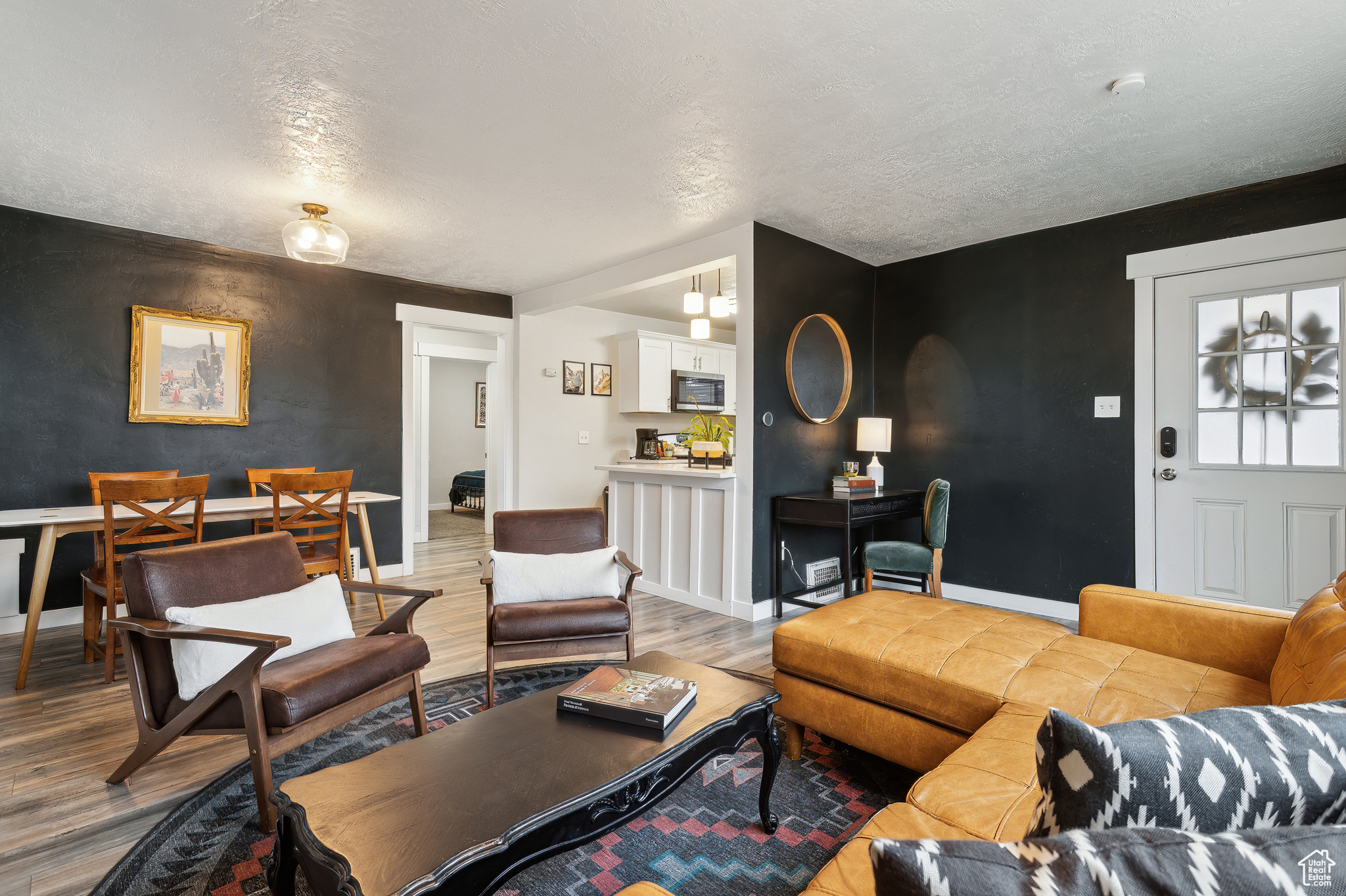 Living room with wood-type flooring and a textured ceiling