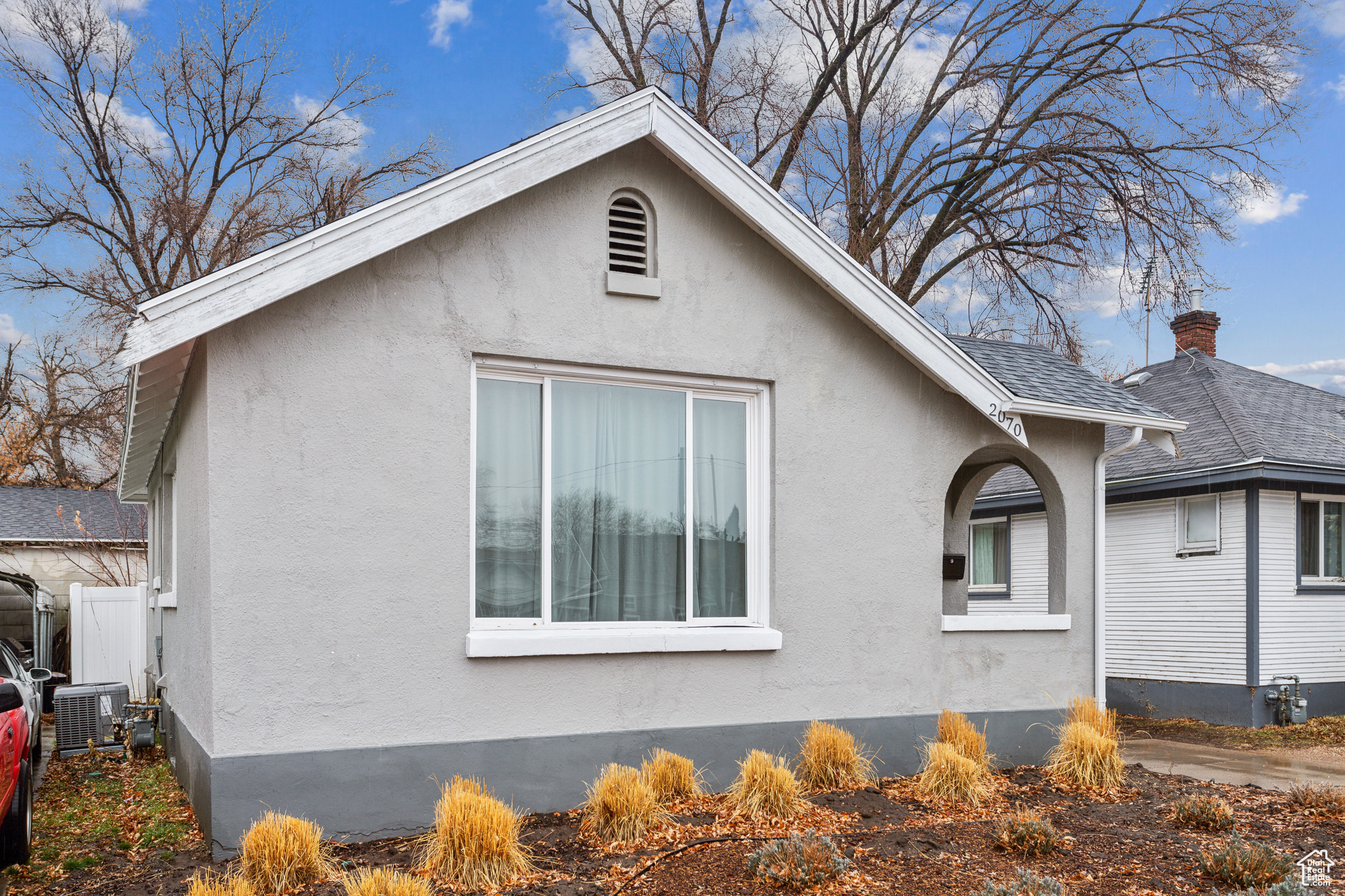 View of side of home with central air condition unit