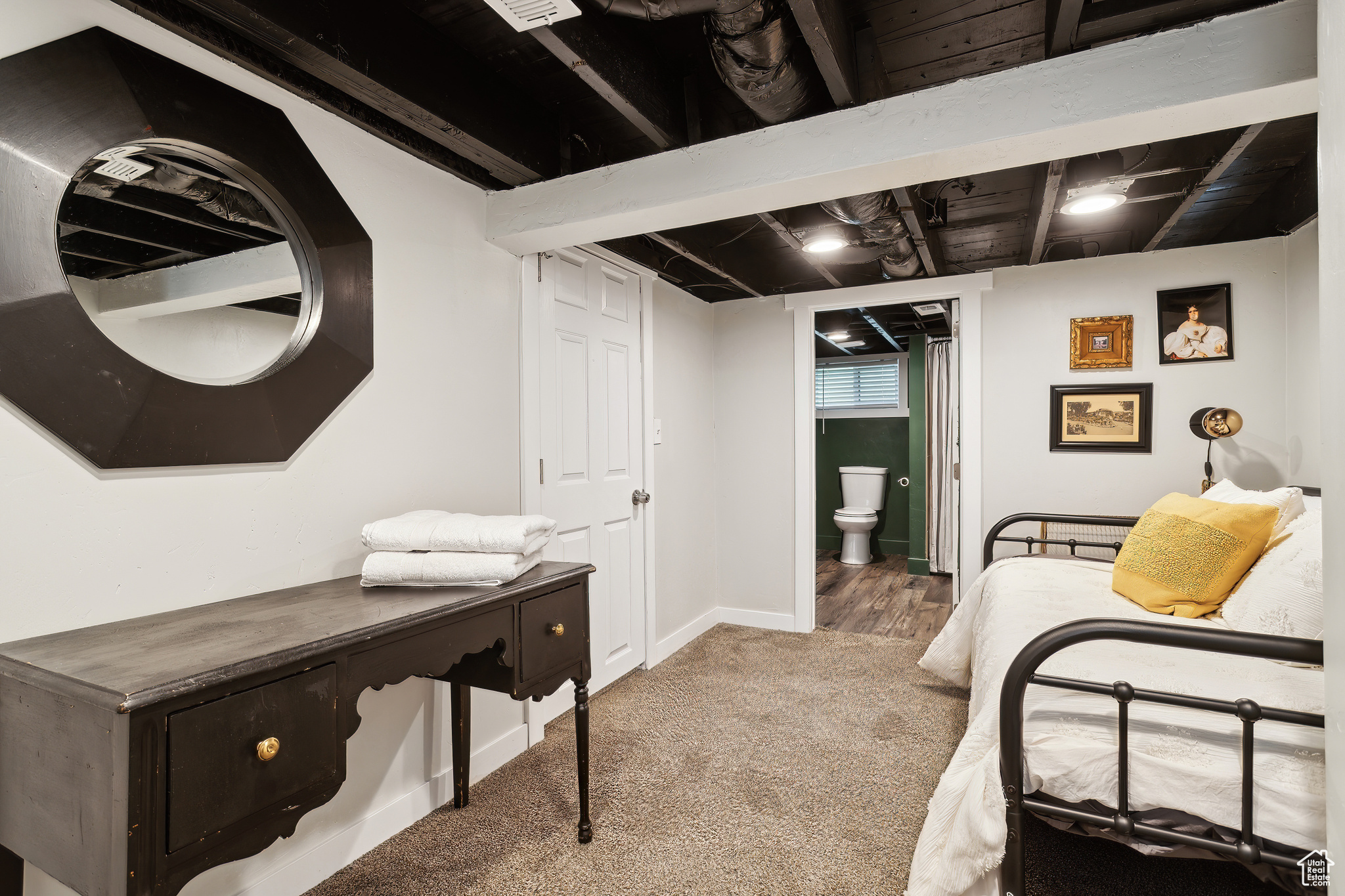 Carpeted bedroom featuring connected bathroom