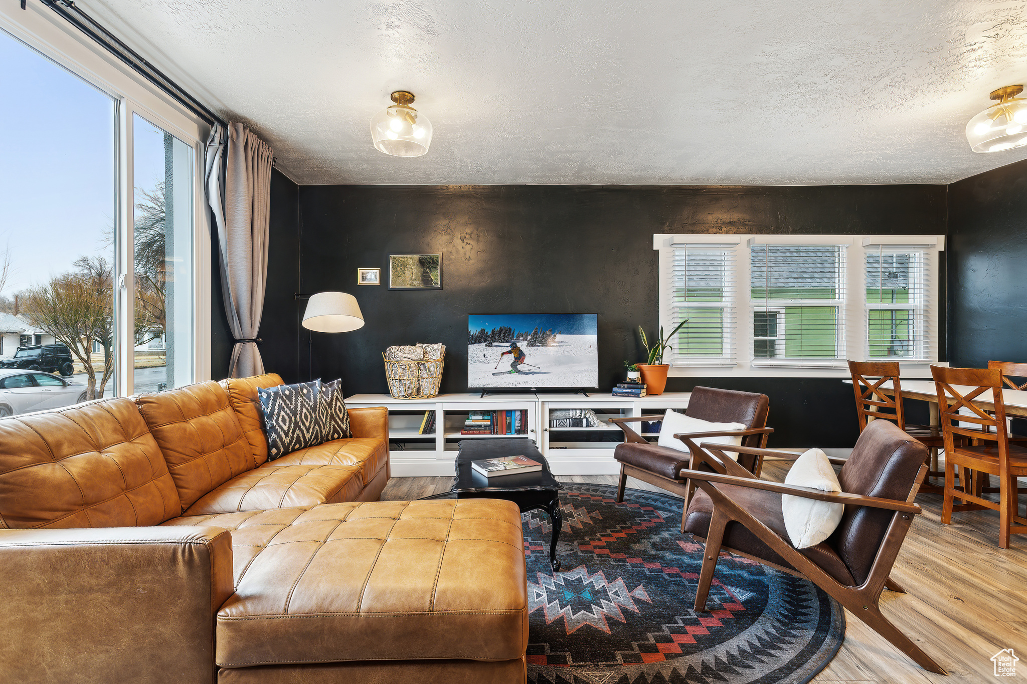Living room with hardwood / wood-style flooring and a textured ceiling