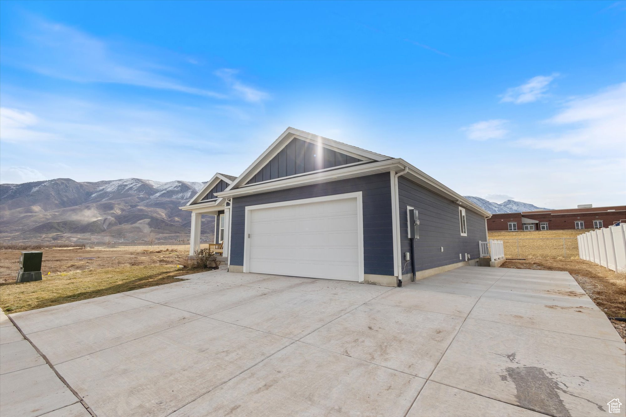 View of home's exterior with a garage and a mountain view