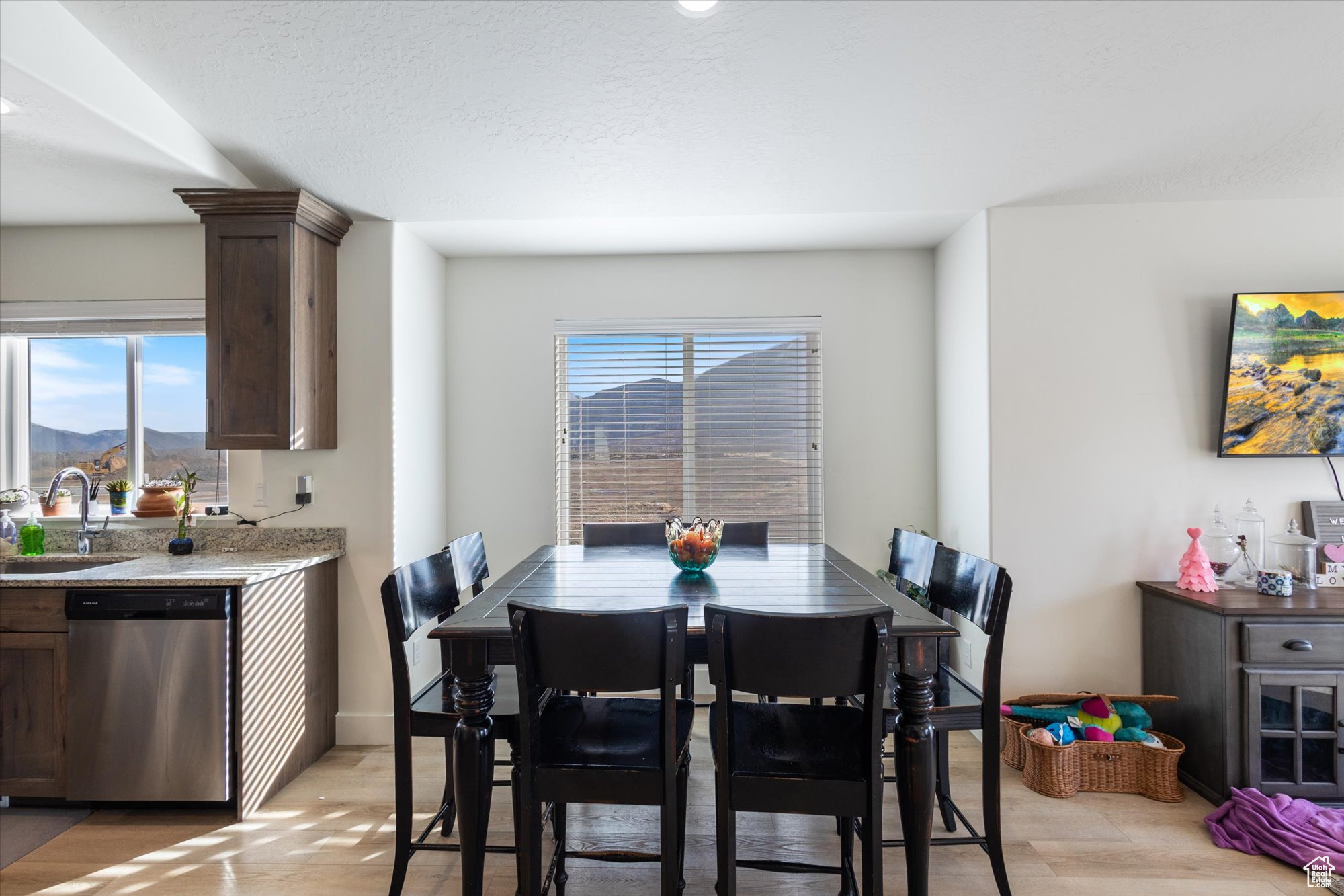 Dining space featuring a mountain view, sink, a wealth of natural light, and light hardwood / wood-style floors
