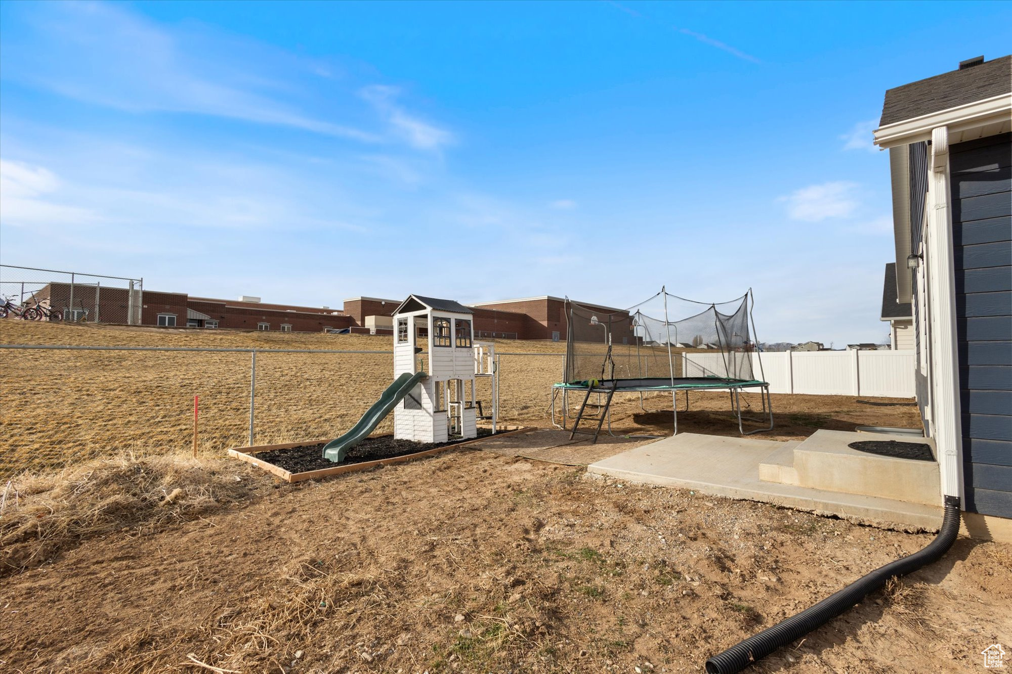 View of yard with a trampoline, a patio area, and a playground