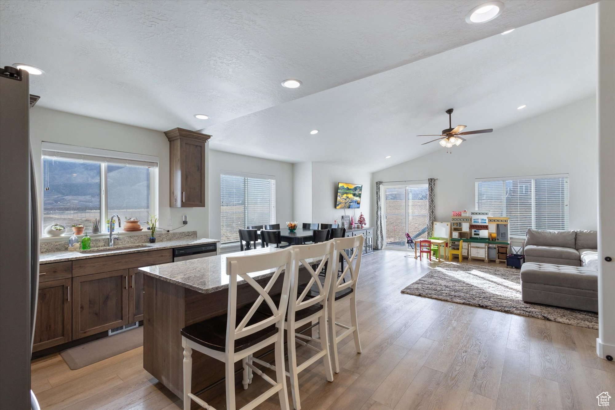 Kitchen featuring a center island, sink, a kitchen bar, and light wood-type flooring
