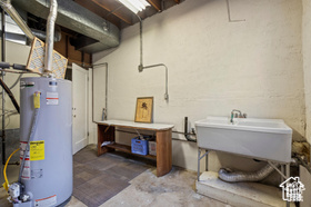 Basement featuring water heater and sink