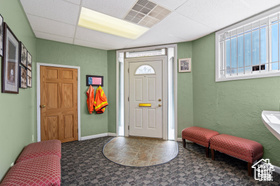 Foyer with a paneled ceiling and a healthy amount of sunlight