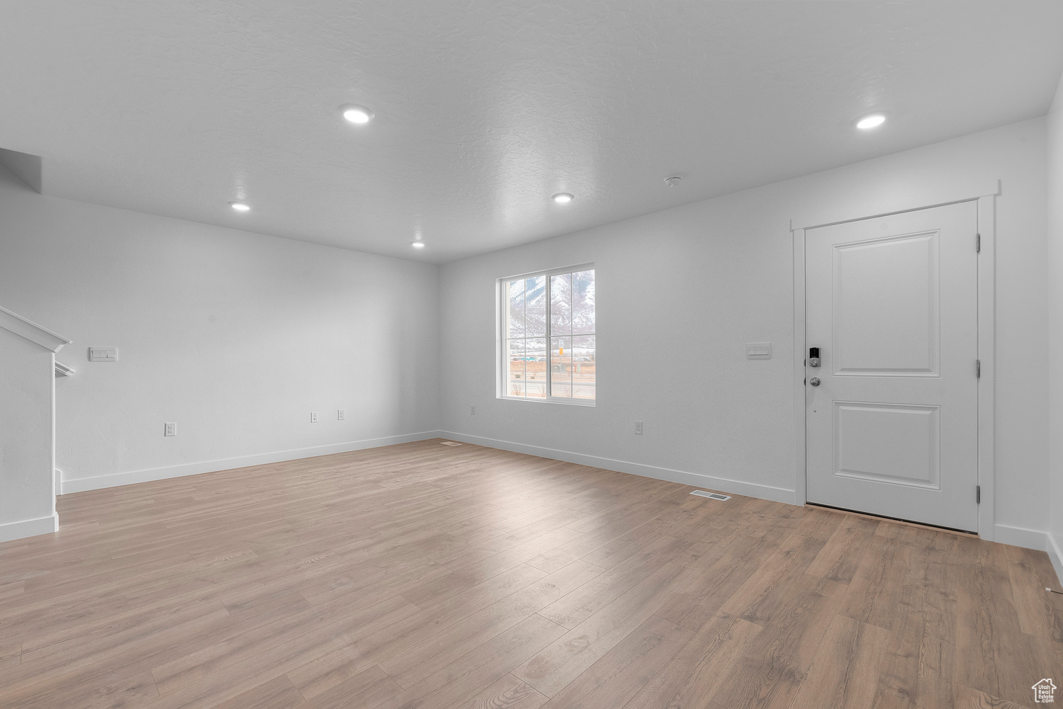Unfurnished living room with light wood-type flooring