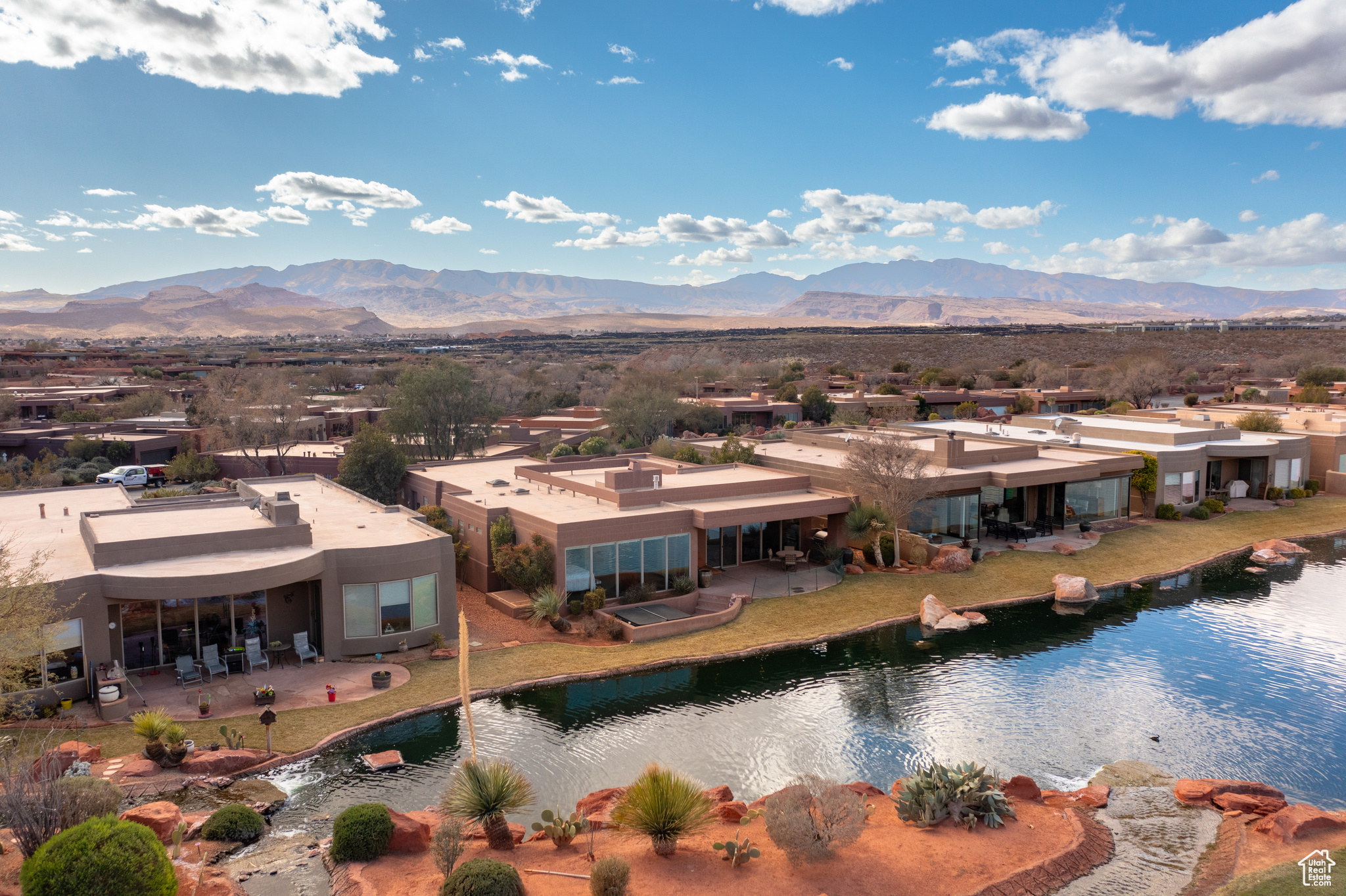 Birds eye view of property with a water and mountain view
