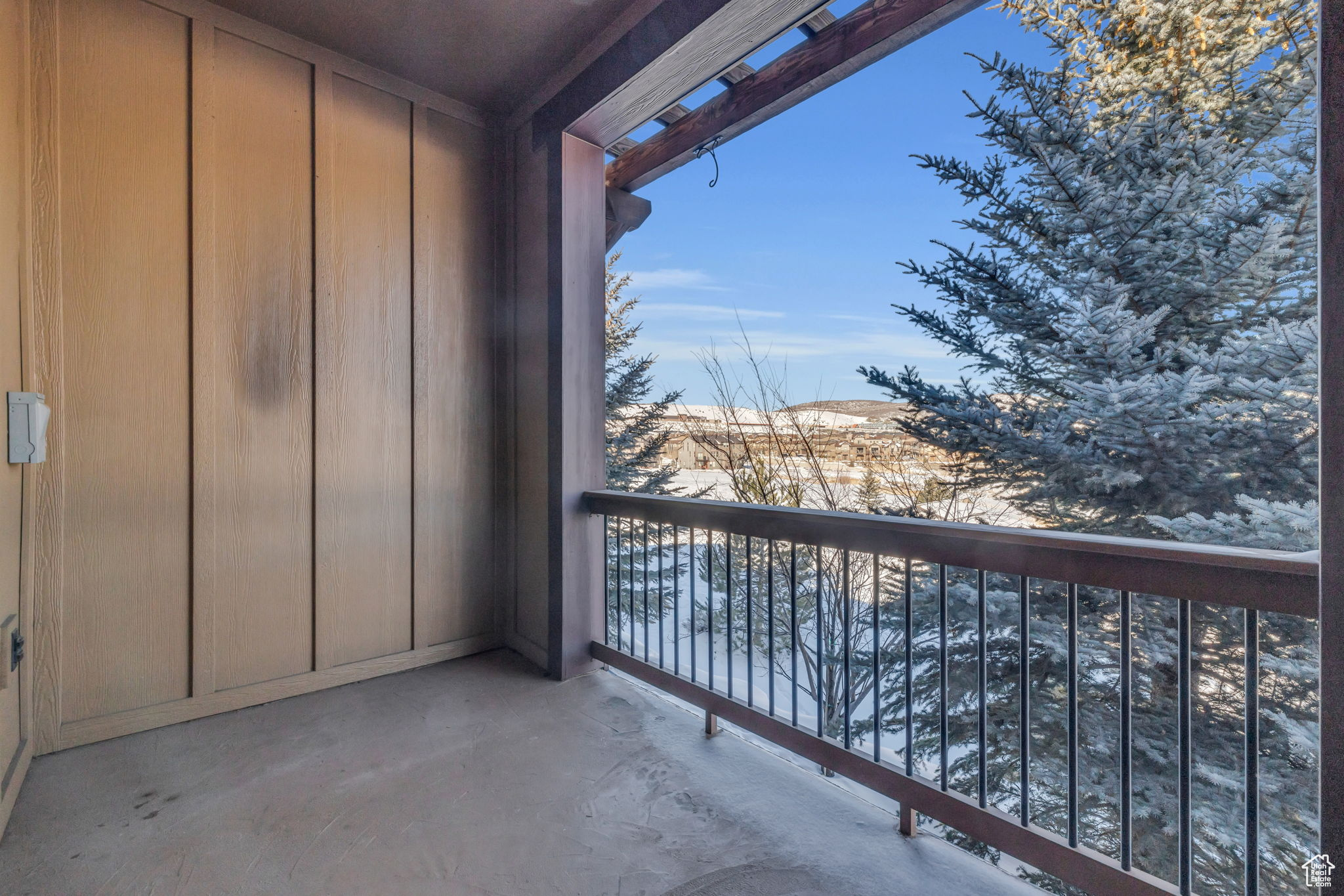 View of snow covered back of property