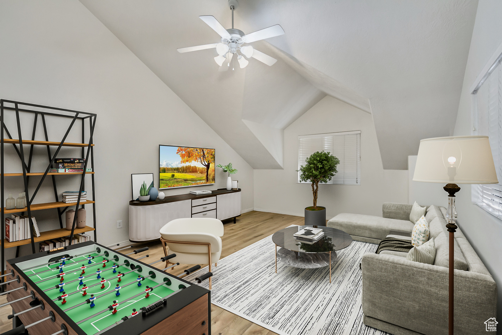 Rec room featuring lofted ceiling, baseboards, a ceiling fan, and wood finished floors