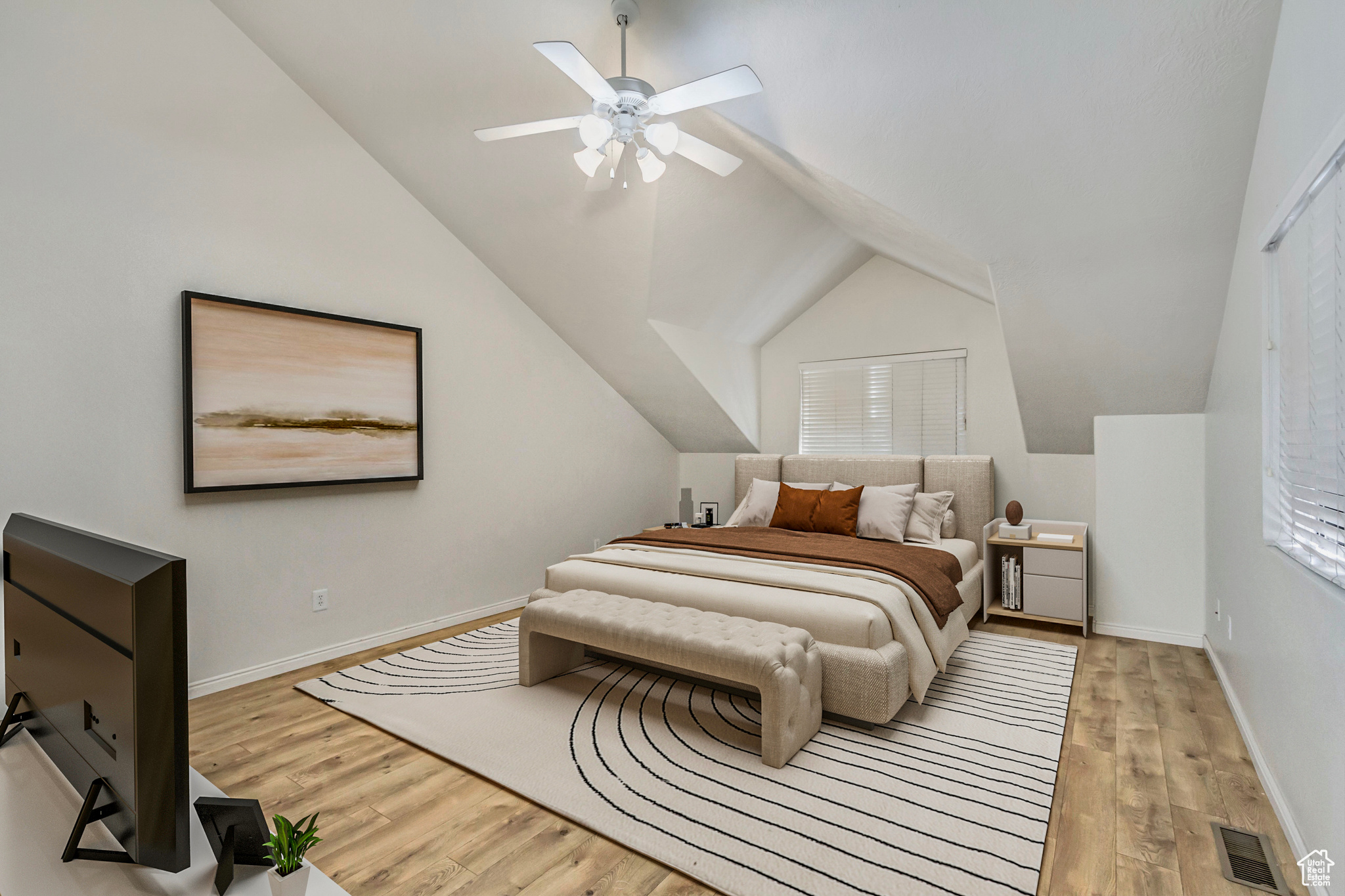 Bedroom with visible vents, vaulted ceiling, ceiling fan, light wood-type flooring, and baseboards