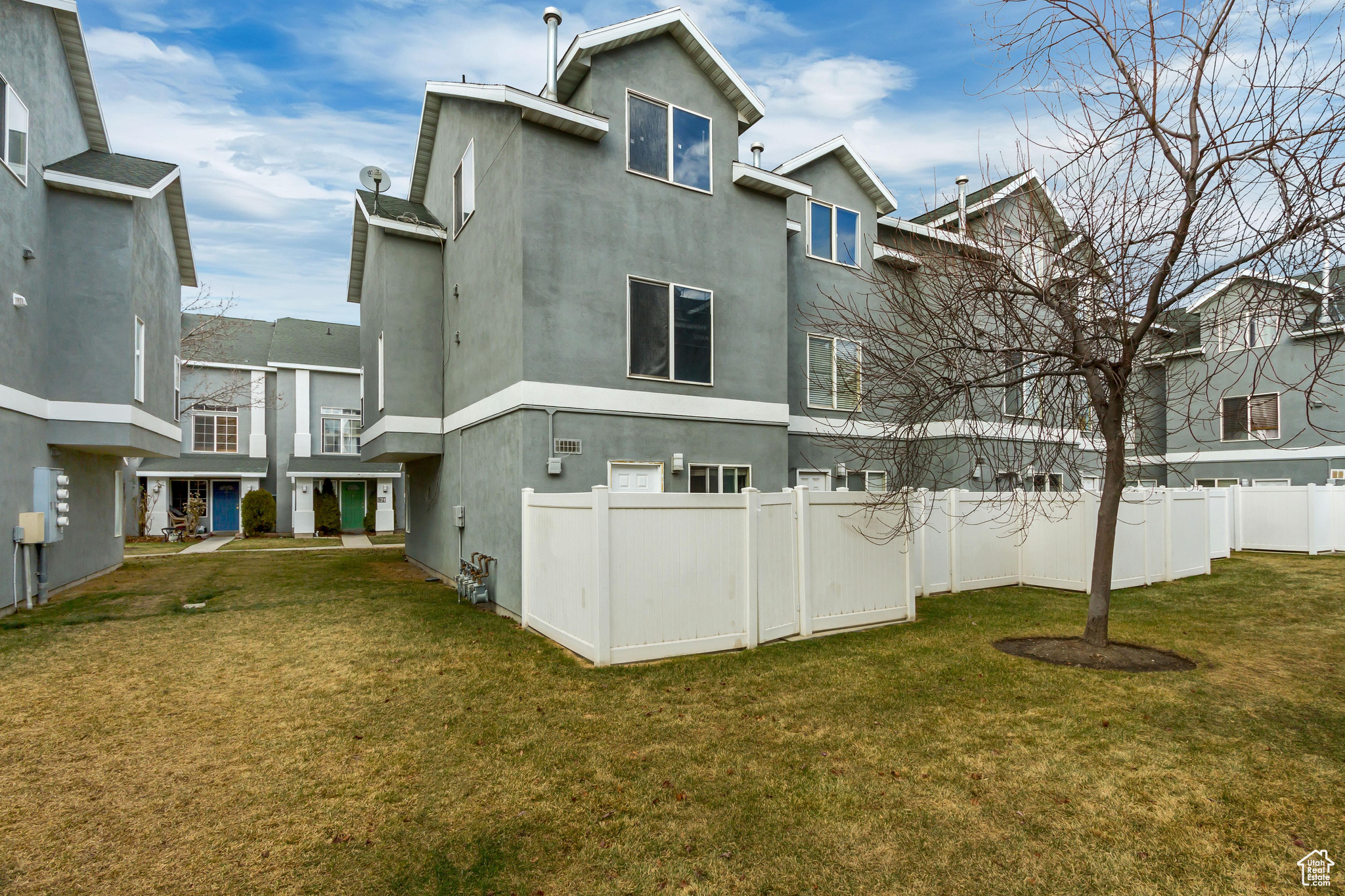Rear view of property with a yard