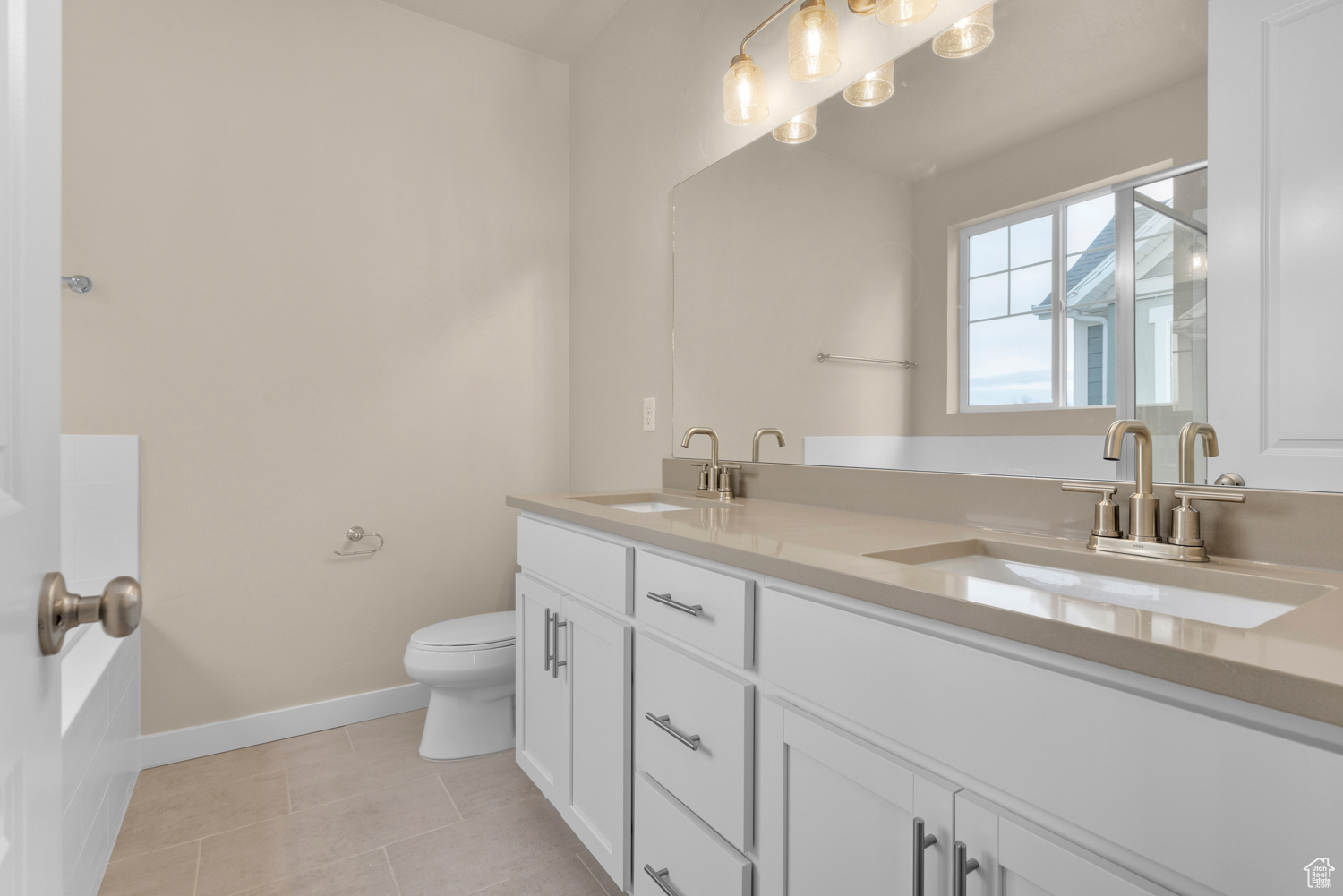 Bathroom featuring tile patterned flooring, vanity, and toilet