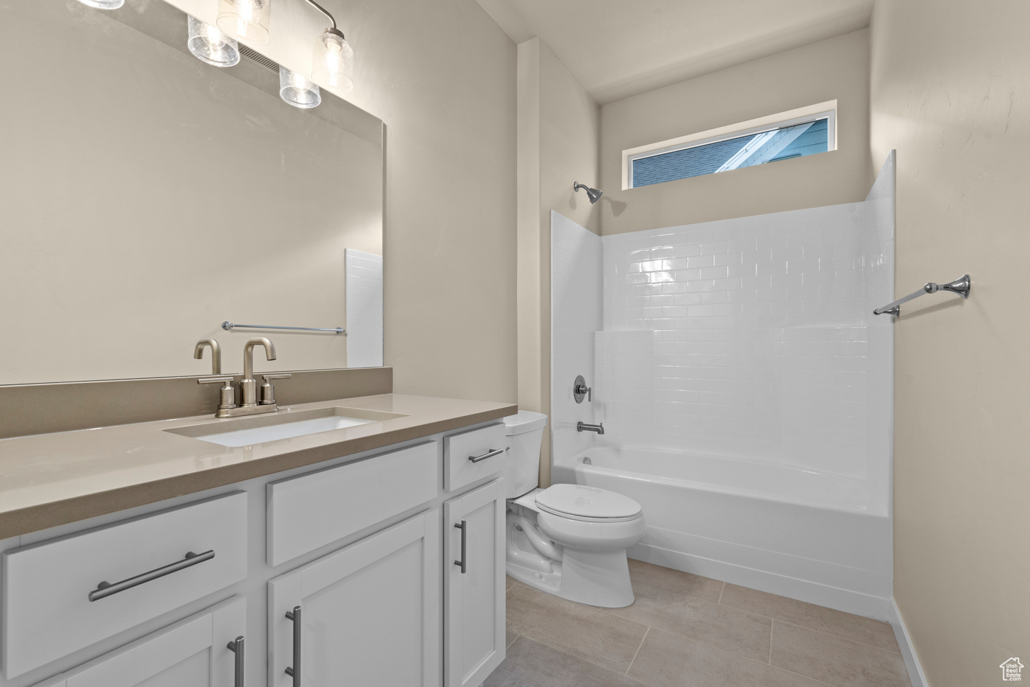 Full bathroom with vanity, toilet, tile patterned flooring, and shower / bathing tub combination