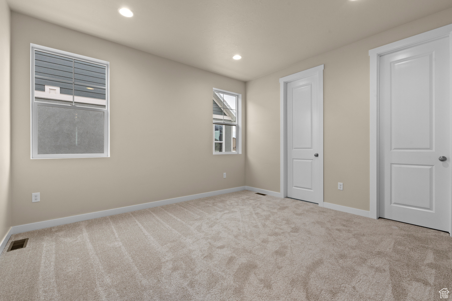 Unfurnished bedroom with light carpet
